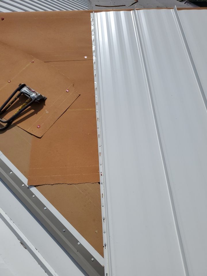 Residential Roofing Installation using 1.5" Nail Strip 24ga Solar White Kynar Coated Standing Seam Metal Panels by Morton Roofing, Inc.