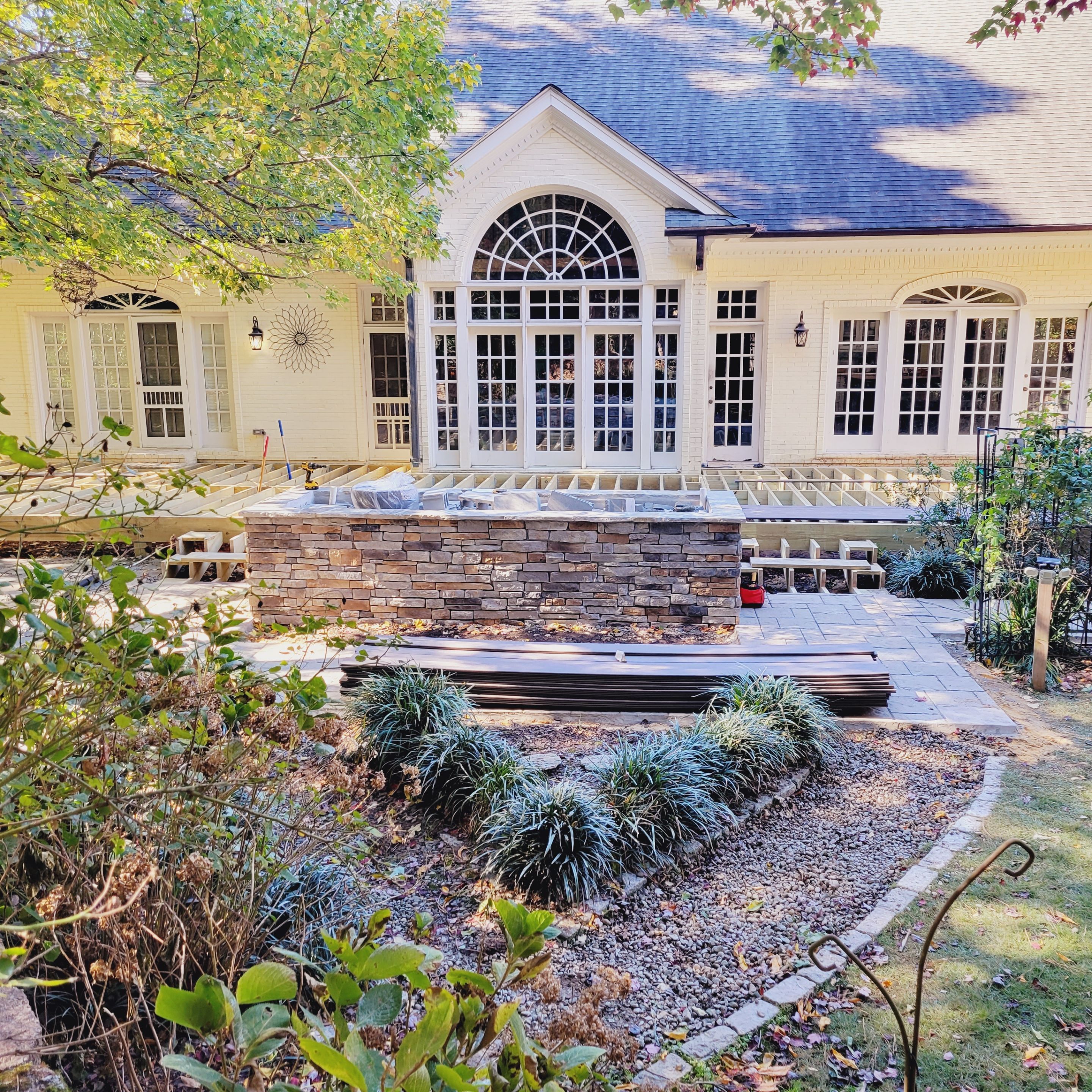 New Deck, Stone Fountain Feature, Circle Stone Sitting Area with Fireplace by The Remodeling Company