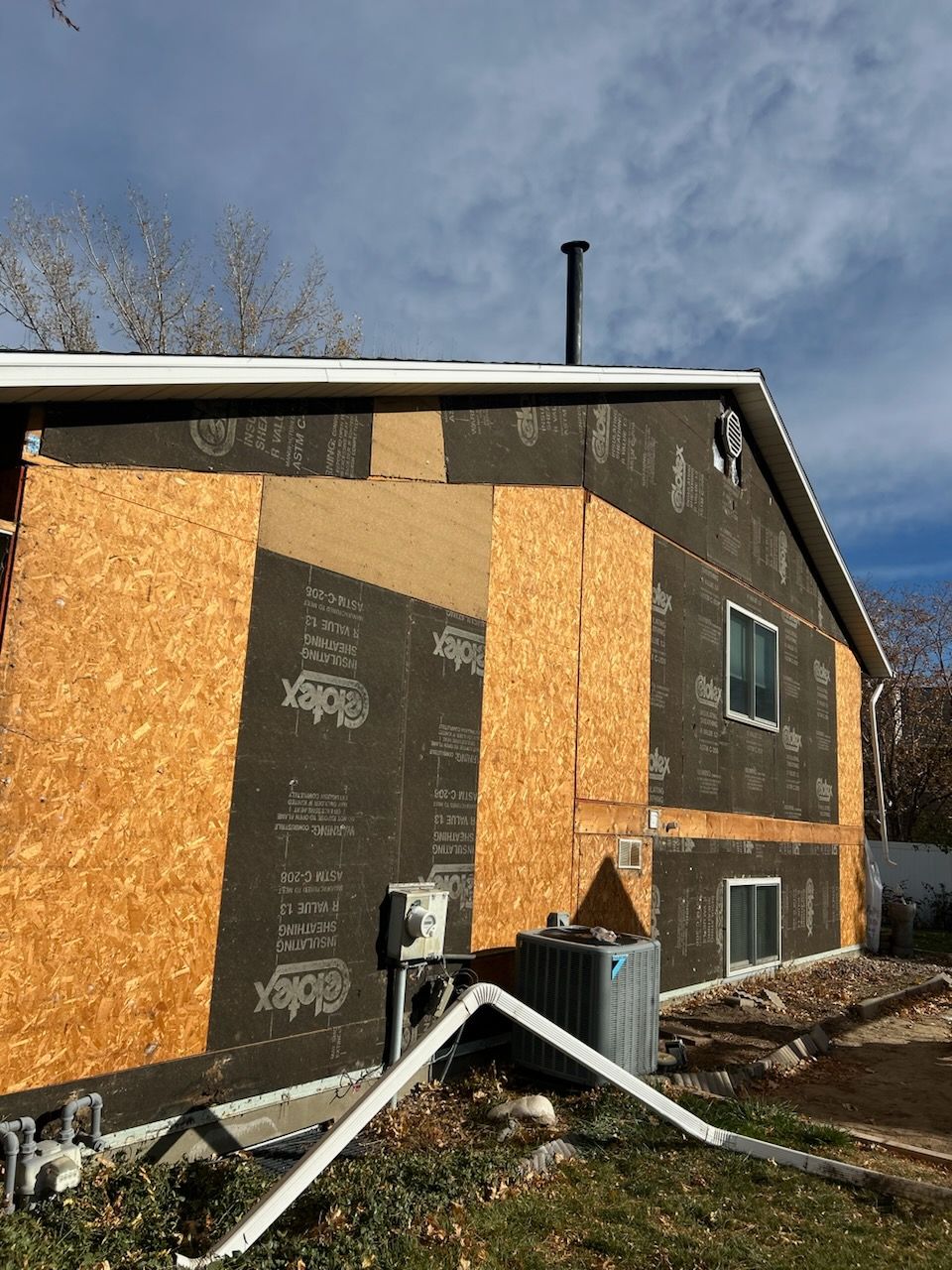Aluminum Siding Replacement with Blue Dutch Lap Vinyl Siding and White Trim by ASAP Roofing & Exteriors