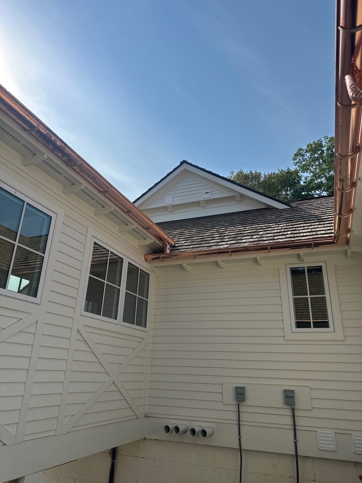 Custom Copper Gutter System and Accent Roofing in East Jordan by Rainbow Seamless Systems