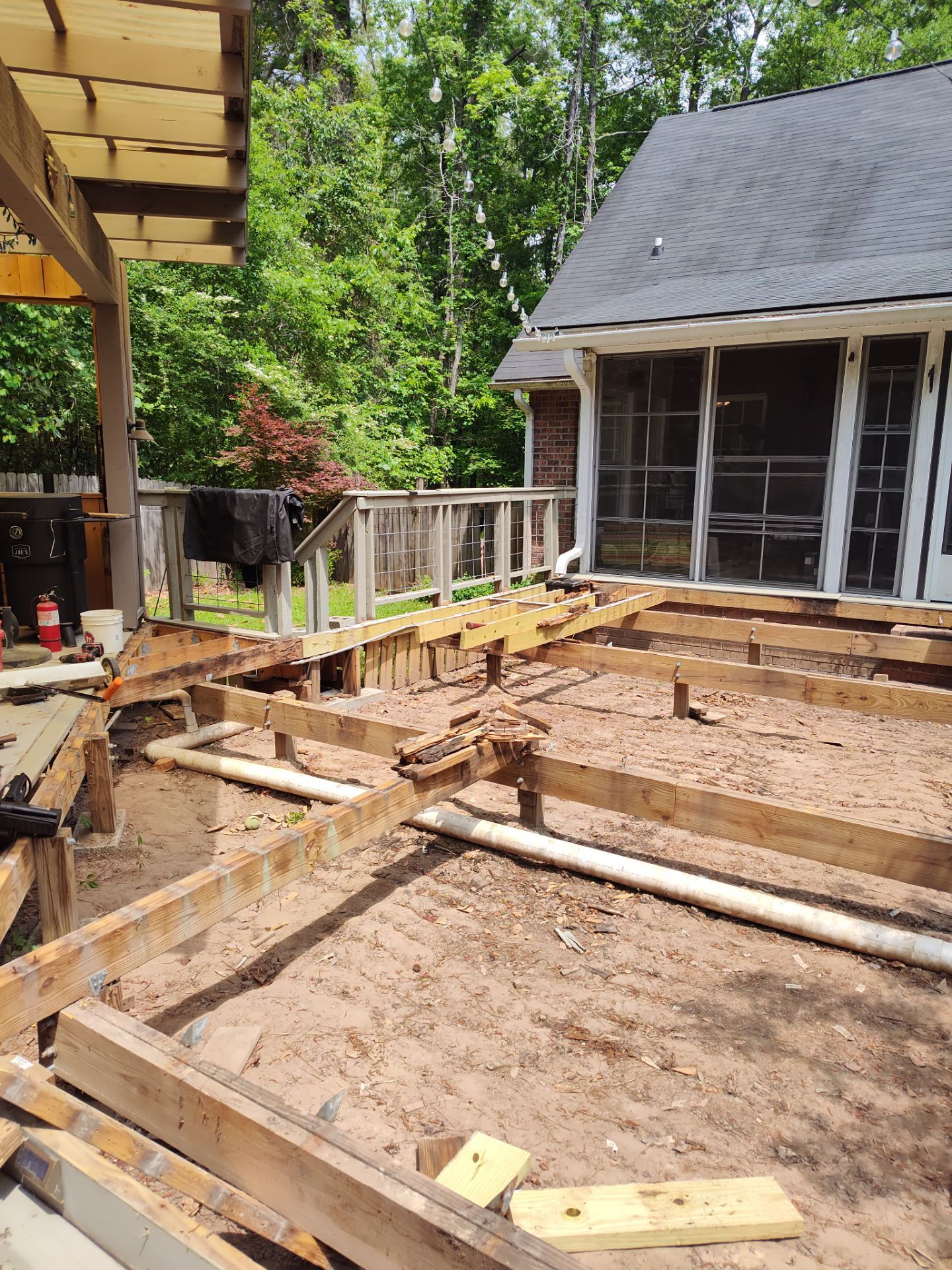 Patio in concrete with drainage improvements by Cornerstone Home Builders, LLC