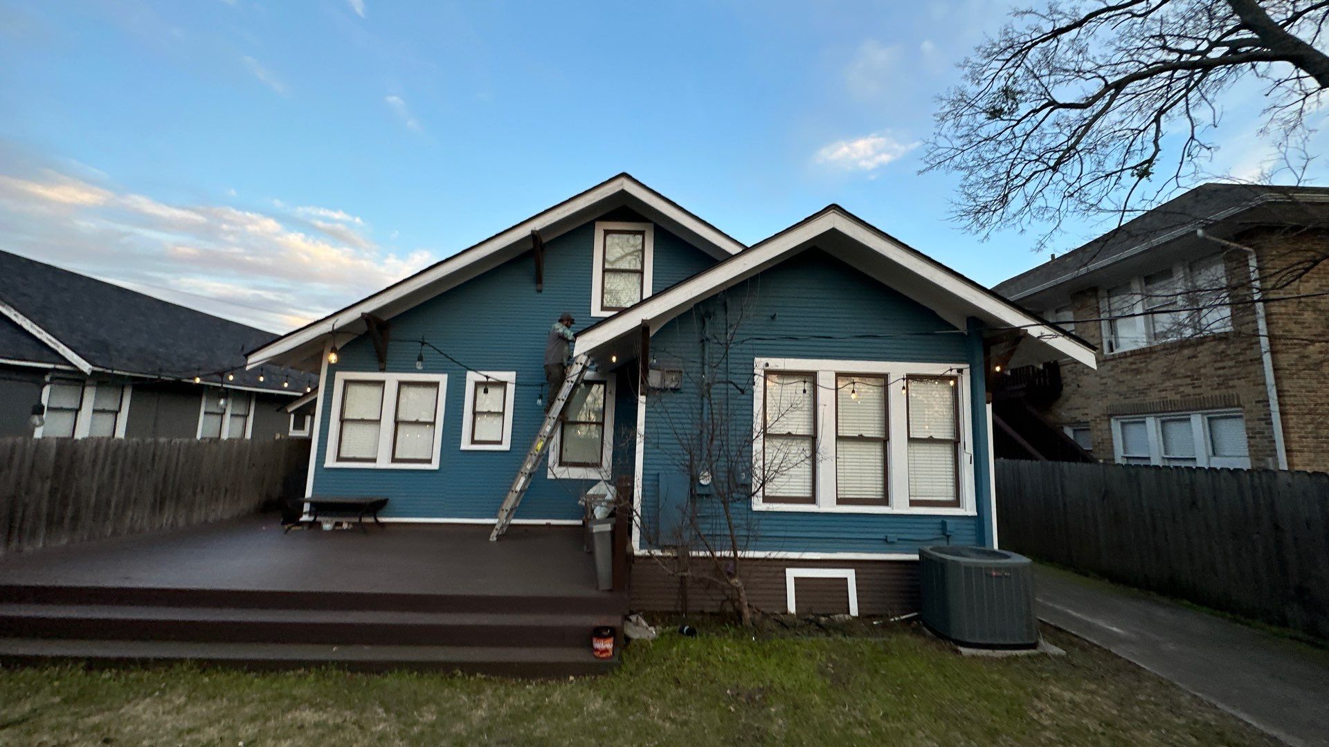 Blue sliding/brick columns on the porch with Malarkey Storm Grey by Tejas Roofworks + Restoration