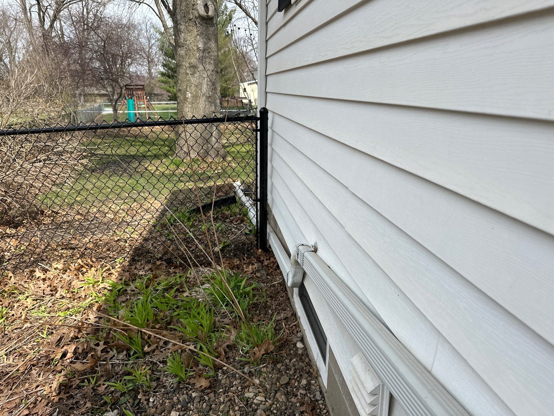Black Vinyl-Coated Chain Link Fence Installation in Cedar Falls by Perfect Picket Fence and Stain