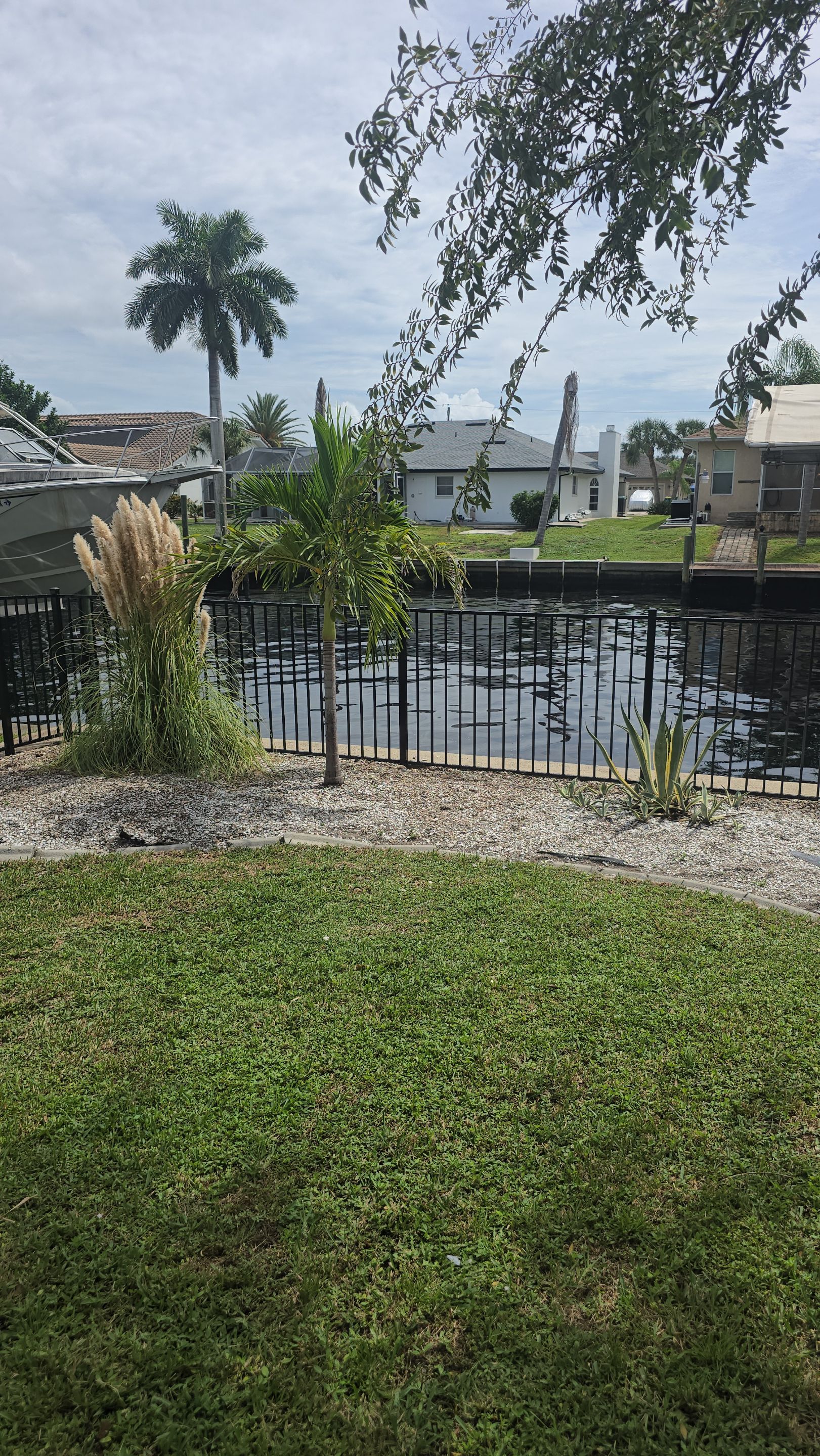 Black Aluminum Picket Fence Installation for Port Charlotte Canal Home by True Fence LLC