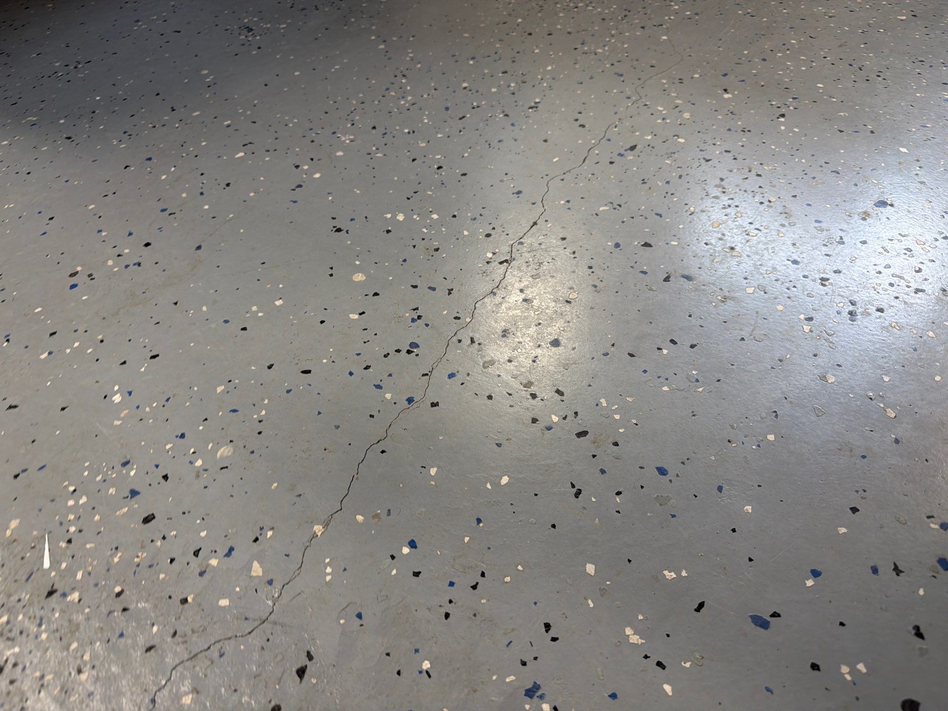 Custom Grey Flake Epoxy Garage Floor Installation in Remsen by Select Painting, Coatings & Garage Cabinets