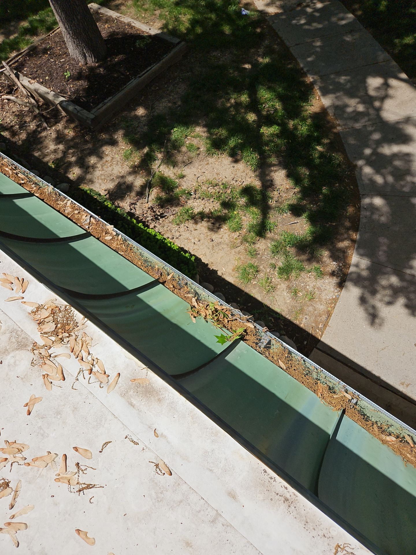 Commercial gutter cleaning Topeka, KS before photo with filled gutters