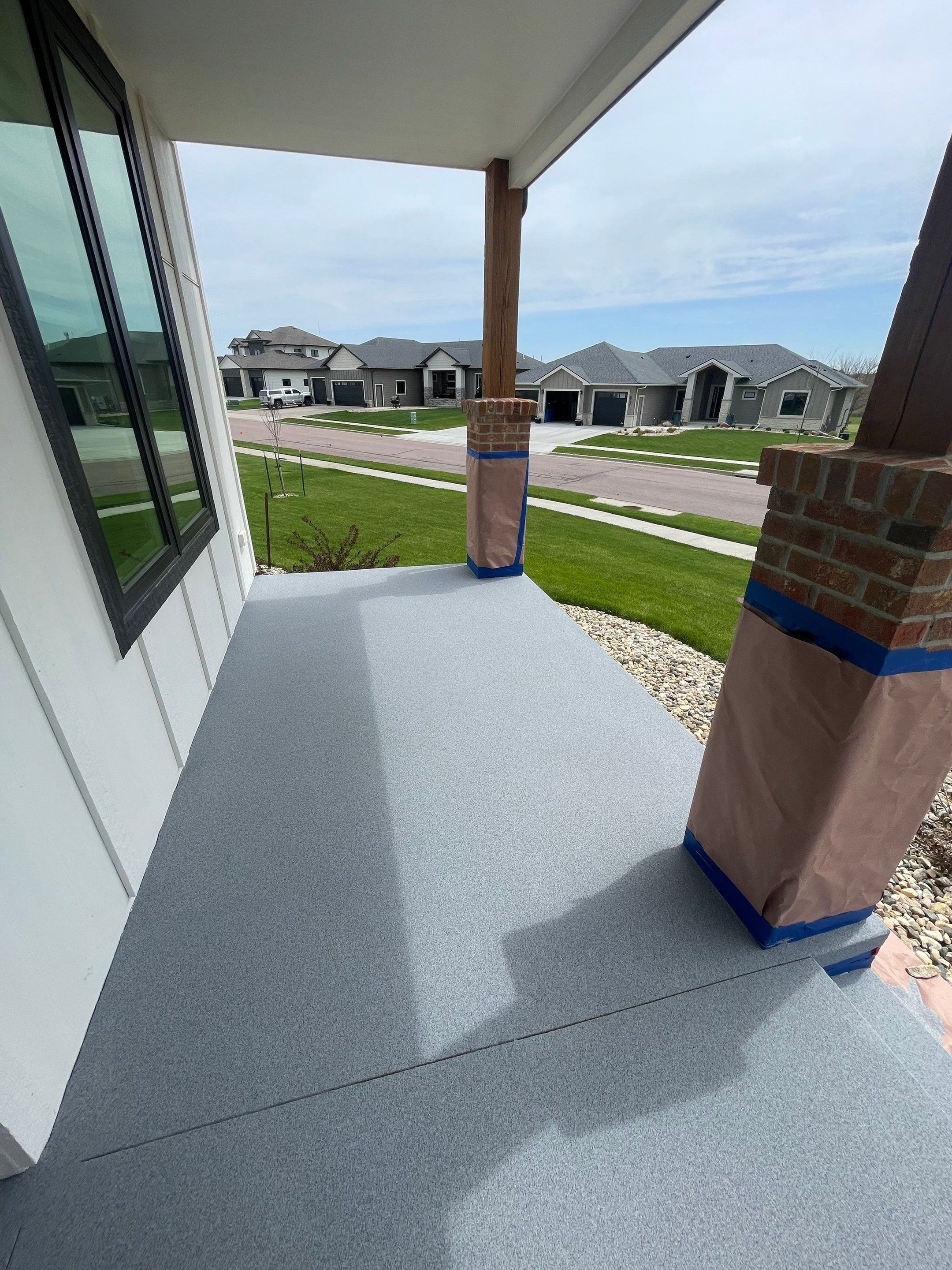Grey Speckled Concrete Porch Coating for Sioux Falls Home by Select Painting, Coatings & Garage Cabinets