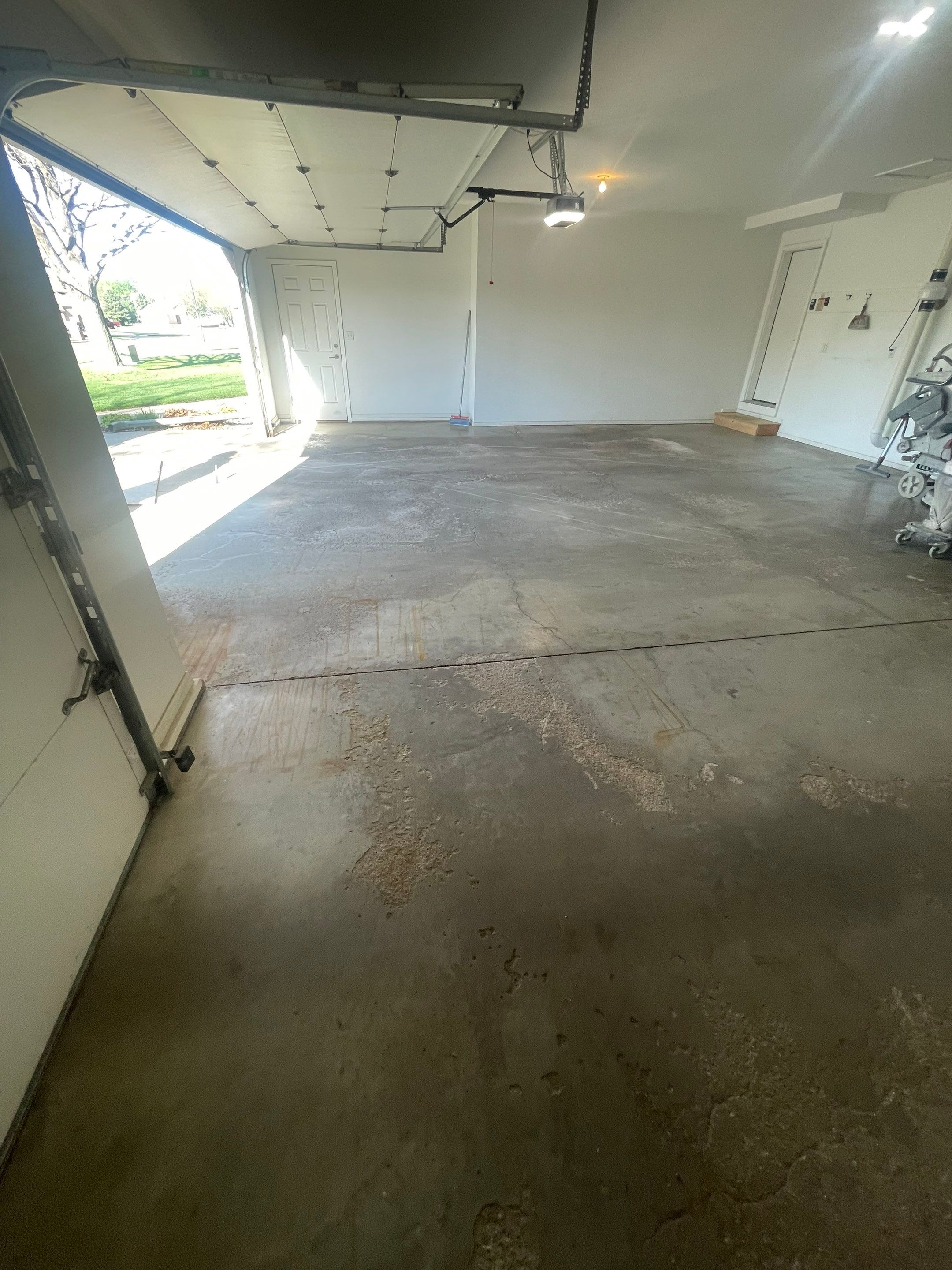 Yankton Garage Floor Restoration with Gray Speckled Epoxy Coating by Select Painting, Coatings & Garage Cabinets