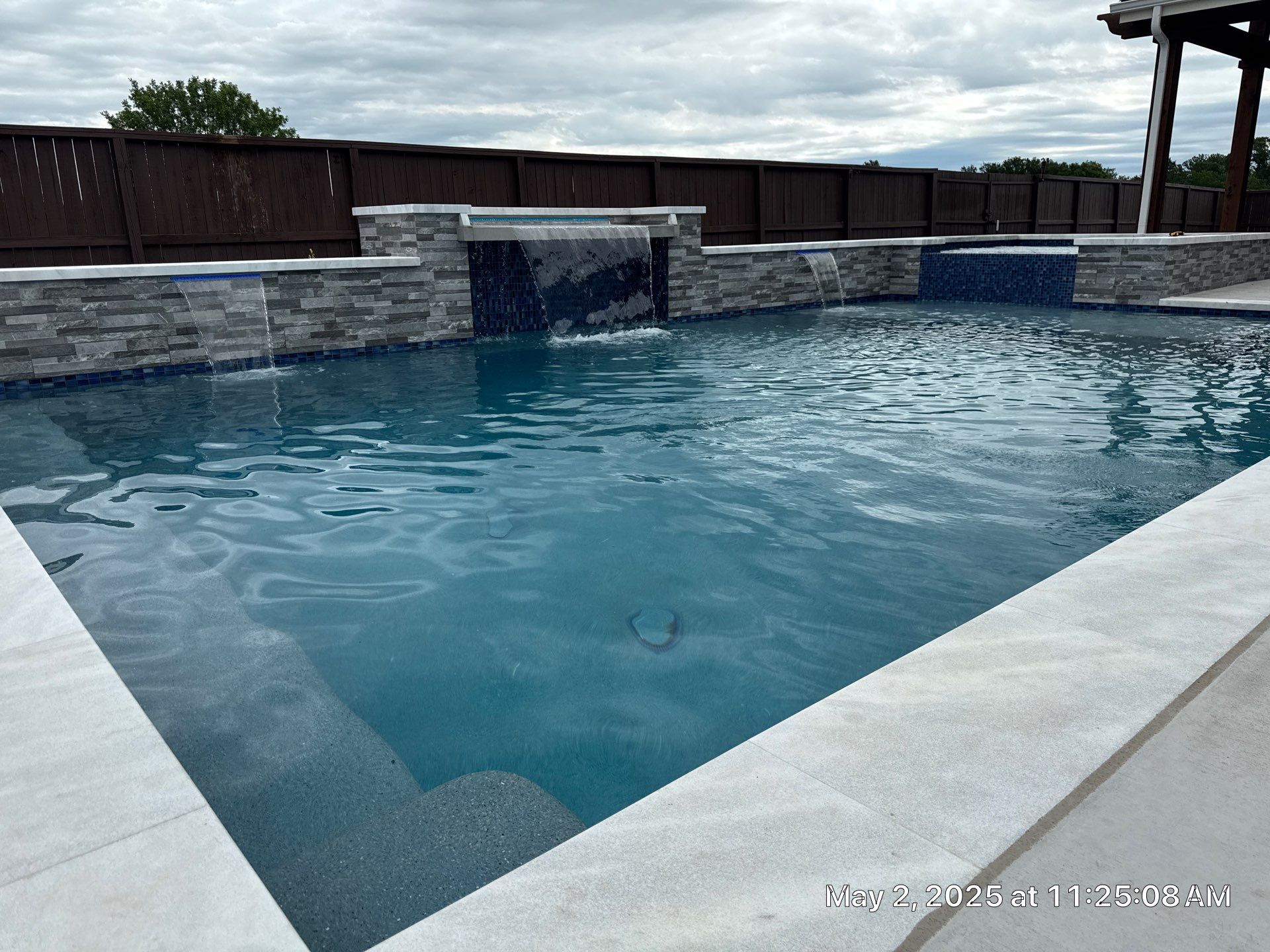 Geometric Pool and Spa with Stone Water Feature Wall by Pinnacle Pools and Spas - DFW