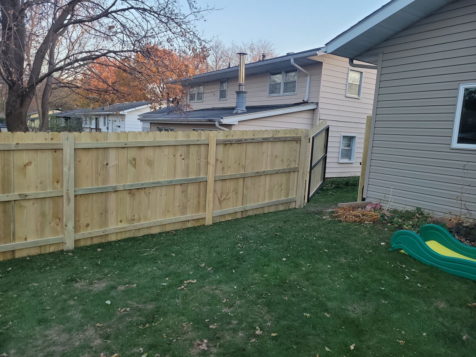 New Pressure-Treated Wood Privacy Fence and Gate in Charles City by Perfect Picket Fence and Stain