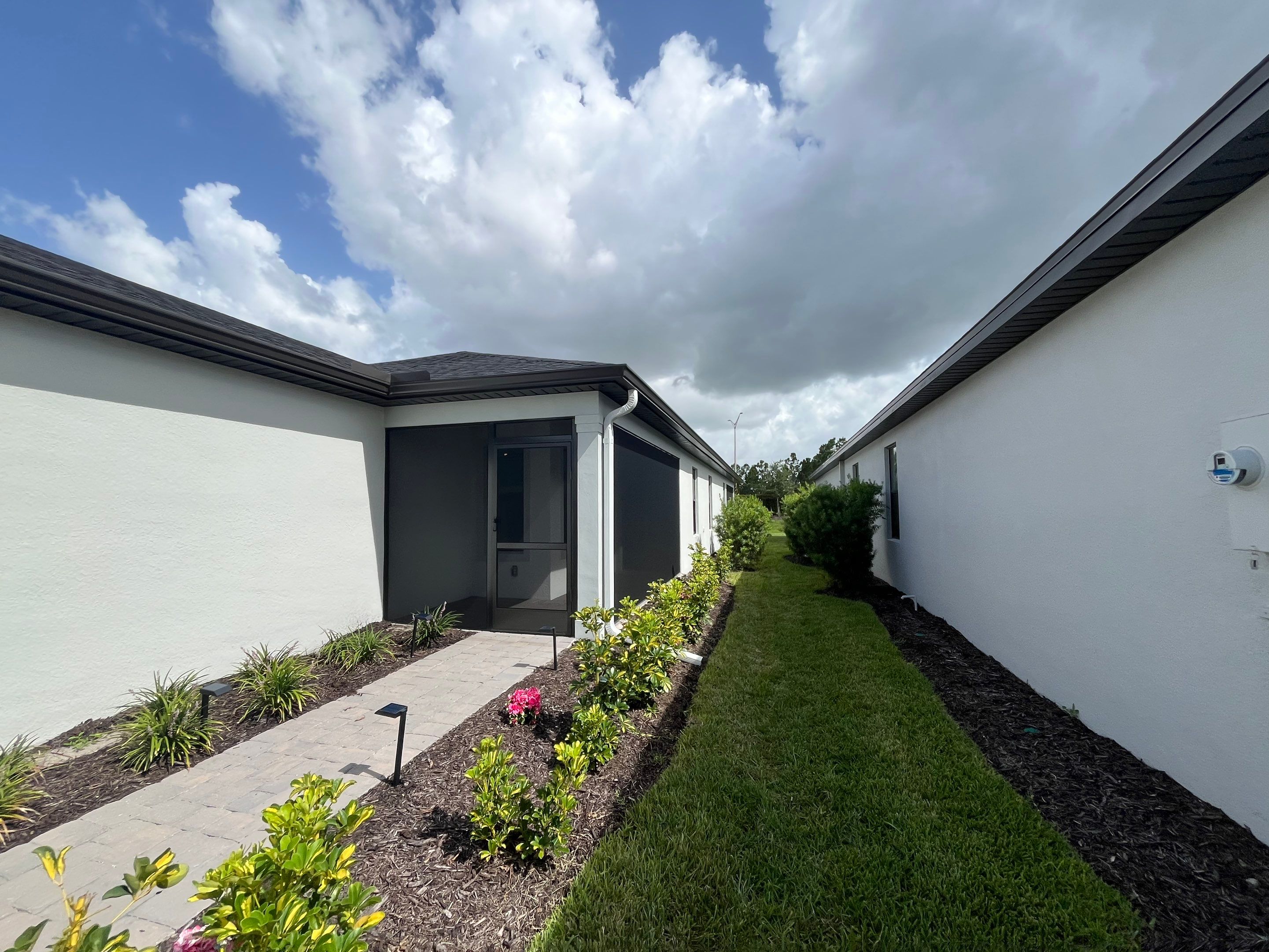 Dark Bronze Gutters and White Downspouts in Sarasota FL by Gutter Professors