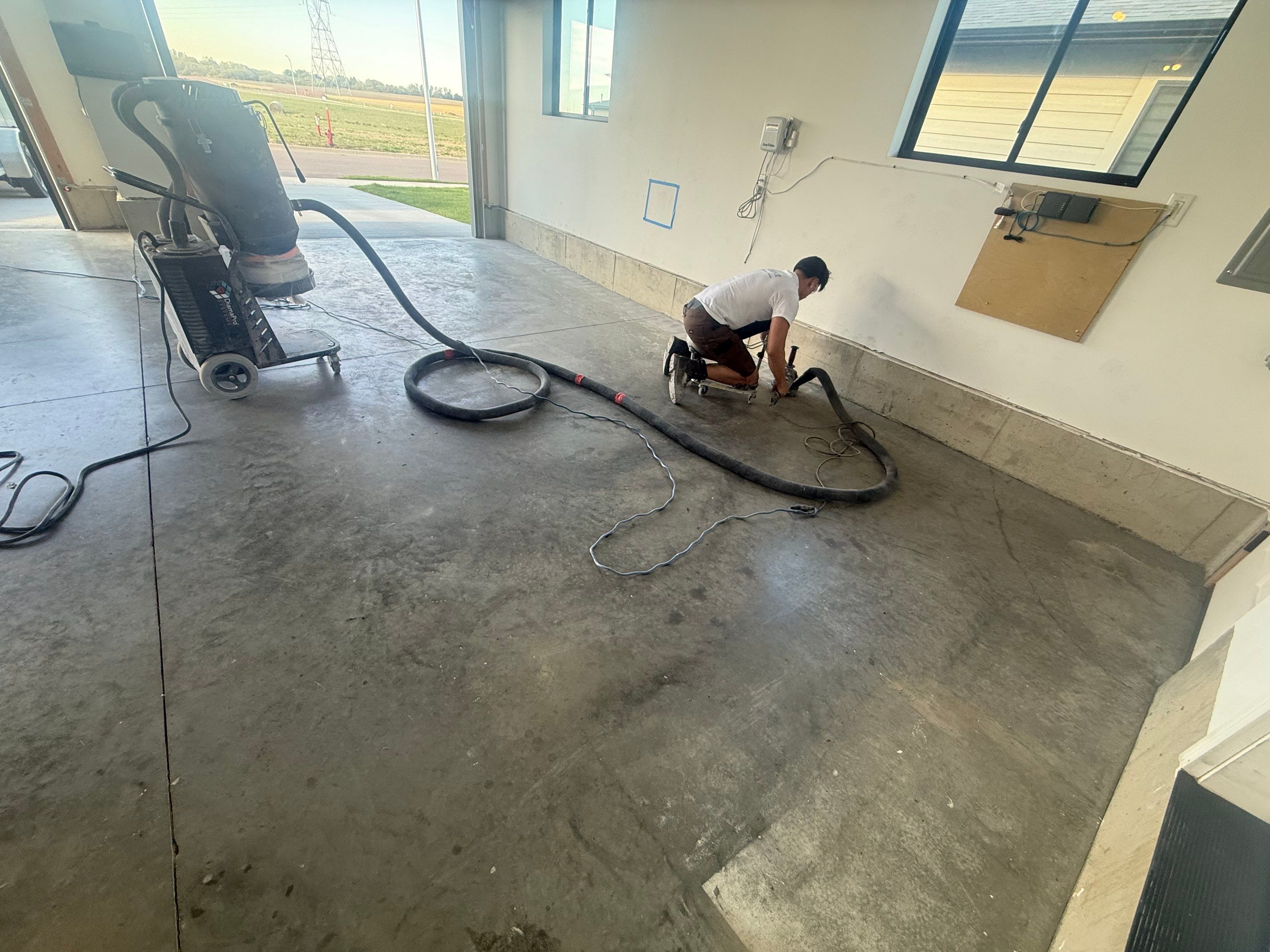 Full Garage Concrete Coating with Grey Speckled Epoxy in Brandon by Select Painting, Coatings & Garage Cabinets