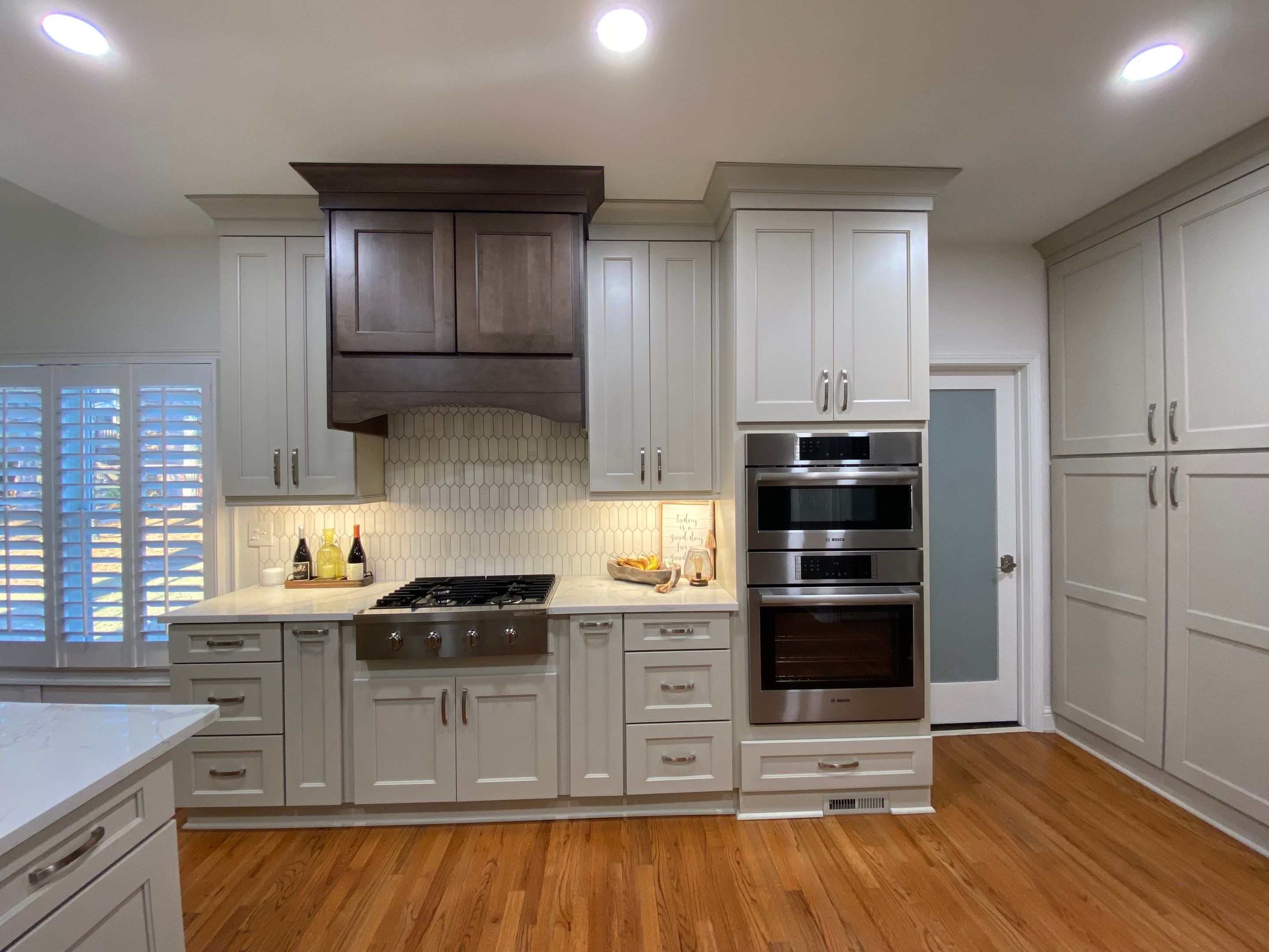 Modern Kitchen Remodeling with Quartz Island and Custom Vent Hood in Woodstock by Swift Home Renovations