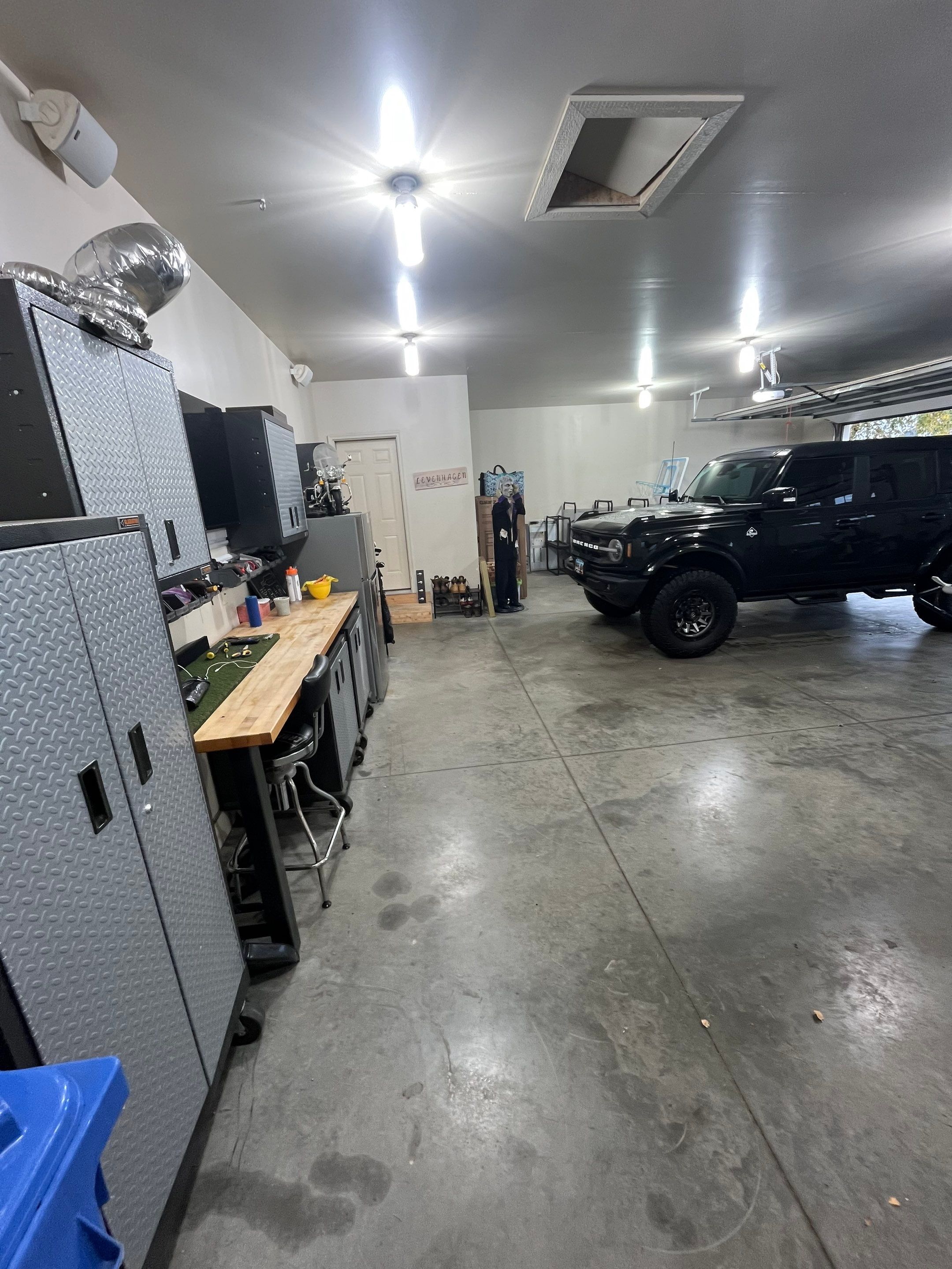Coyote Flake Garage Floor Coating in Sioux Falls with Trench Drain by Select Painting, Coatings & Garage Cabinets