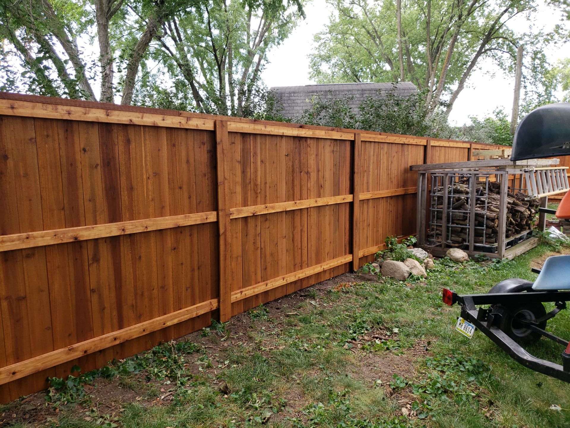 Custom Cedar Privacy Fence with Decorative Gate Windows in Cedar Falls by Perfect Picket Fence and Stain