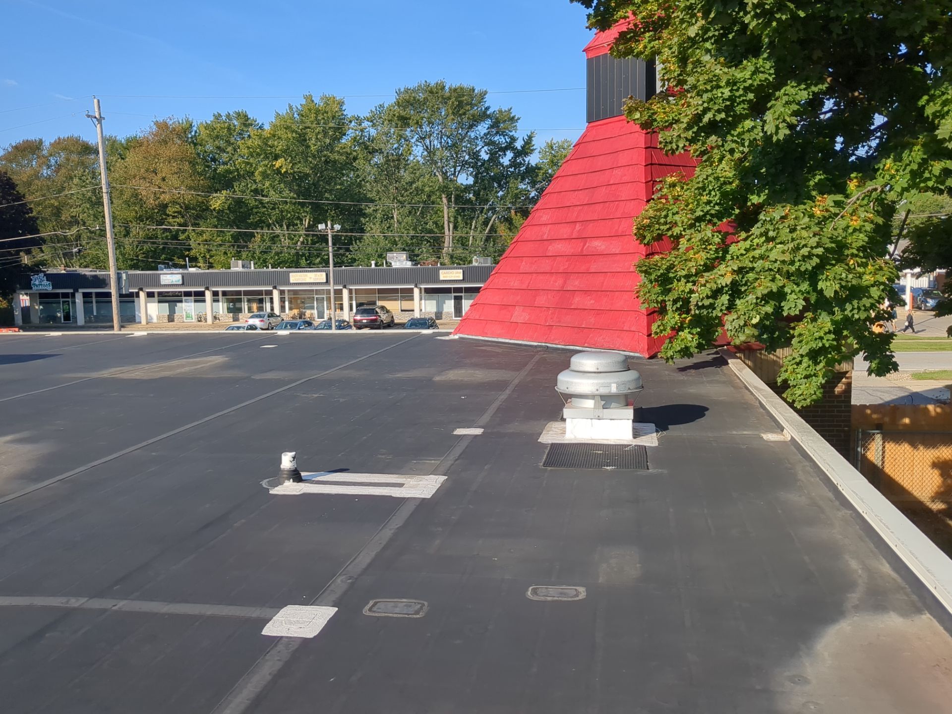 Commercial Roofing Repair using UniFlex Silicone Roof Coating on KinderCare Learning Center by 3 Daughters Construction 