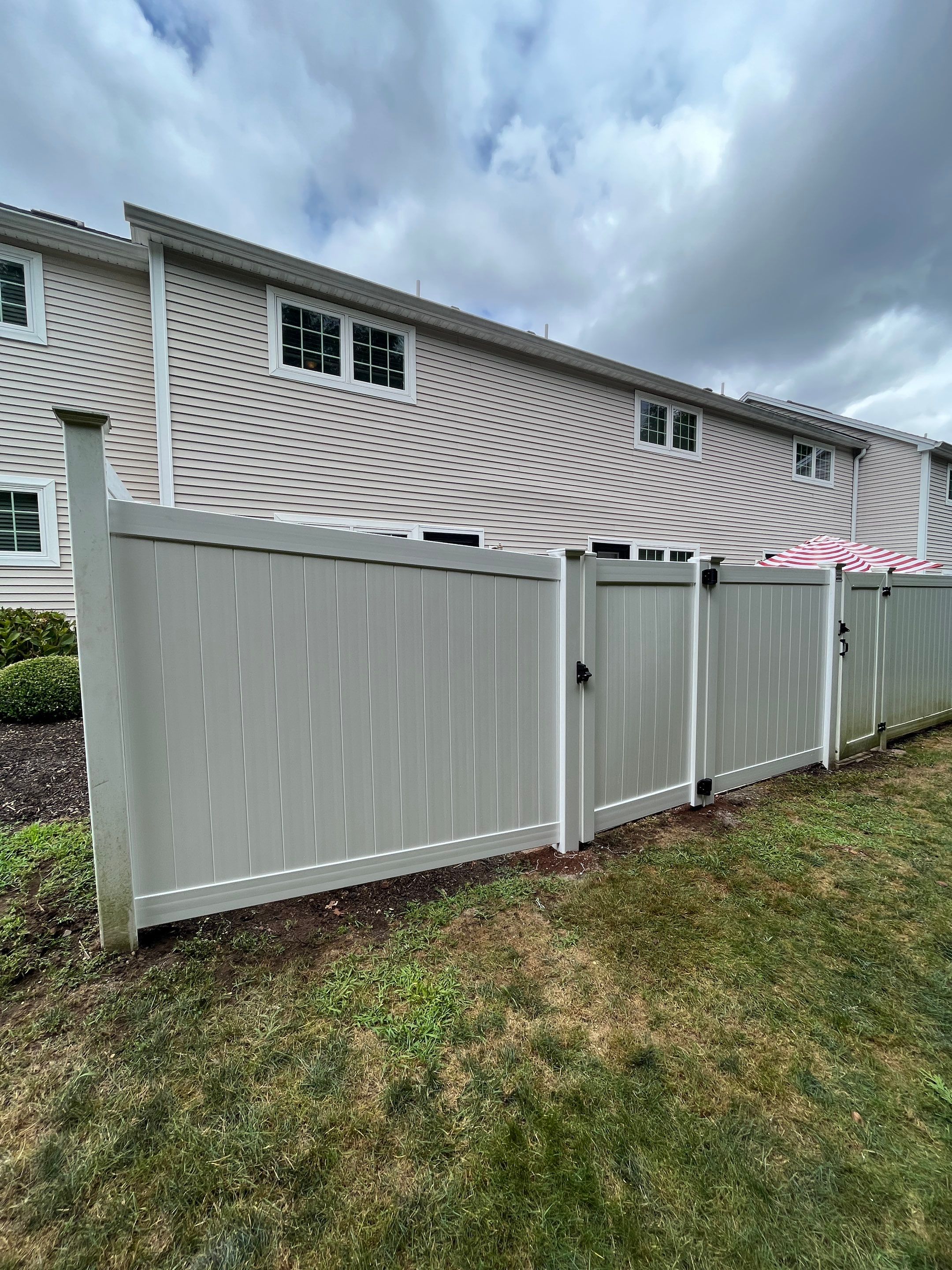 Vinyl privacy fence and matching gate  by DiGiorgi Roofing and Siding Inc