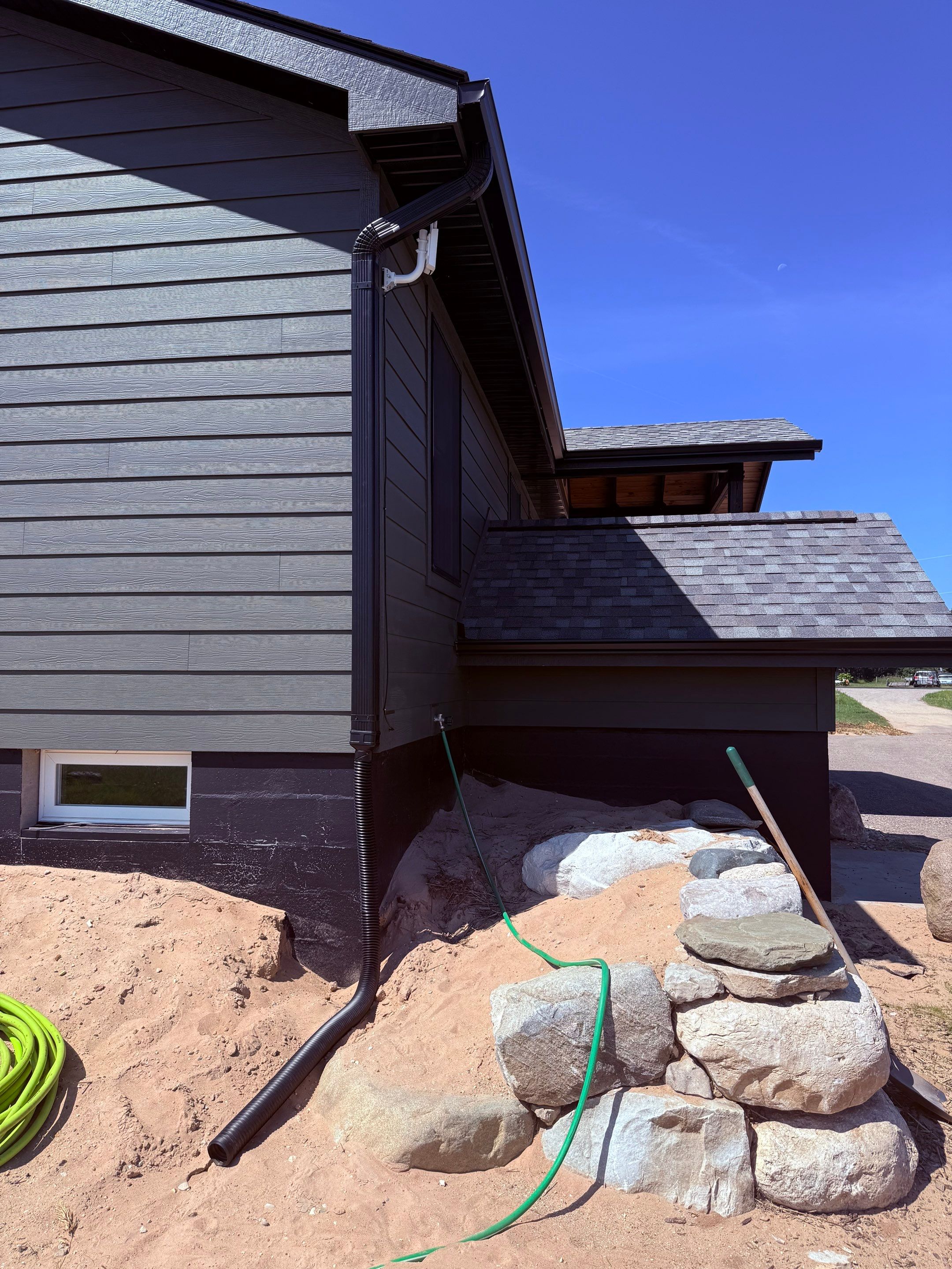 Seamless Black Gutter and Downspout Installation in Bear Lake by Rainbow Seamless Systems