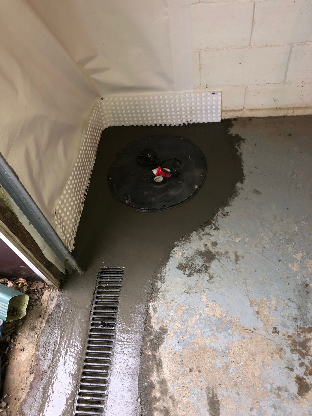 Basement Waterproofing using Drain tile system and a foundation wrap by ACE Waterproofing & Basement Solutions