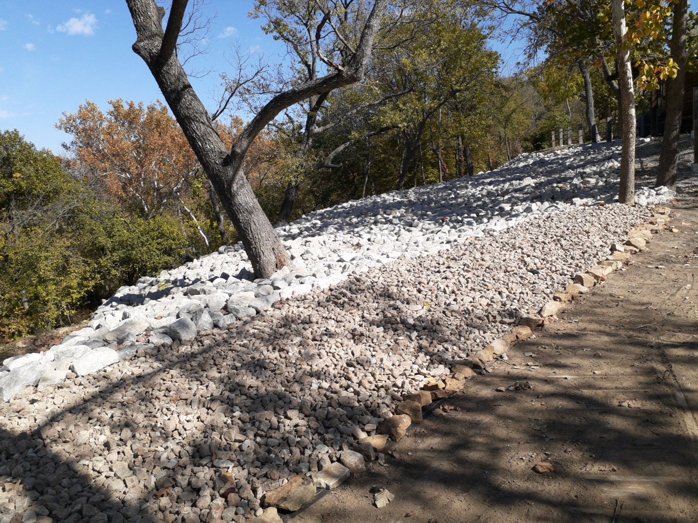 Supporting back of home with backfill at edge of steep creek by LAND ESCAPES LLC