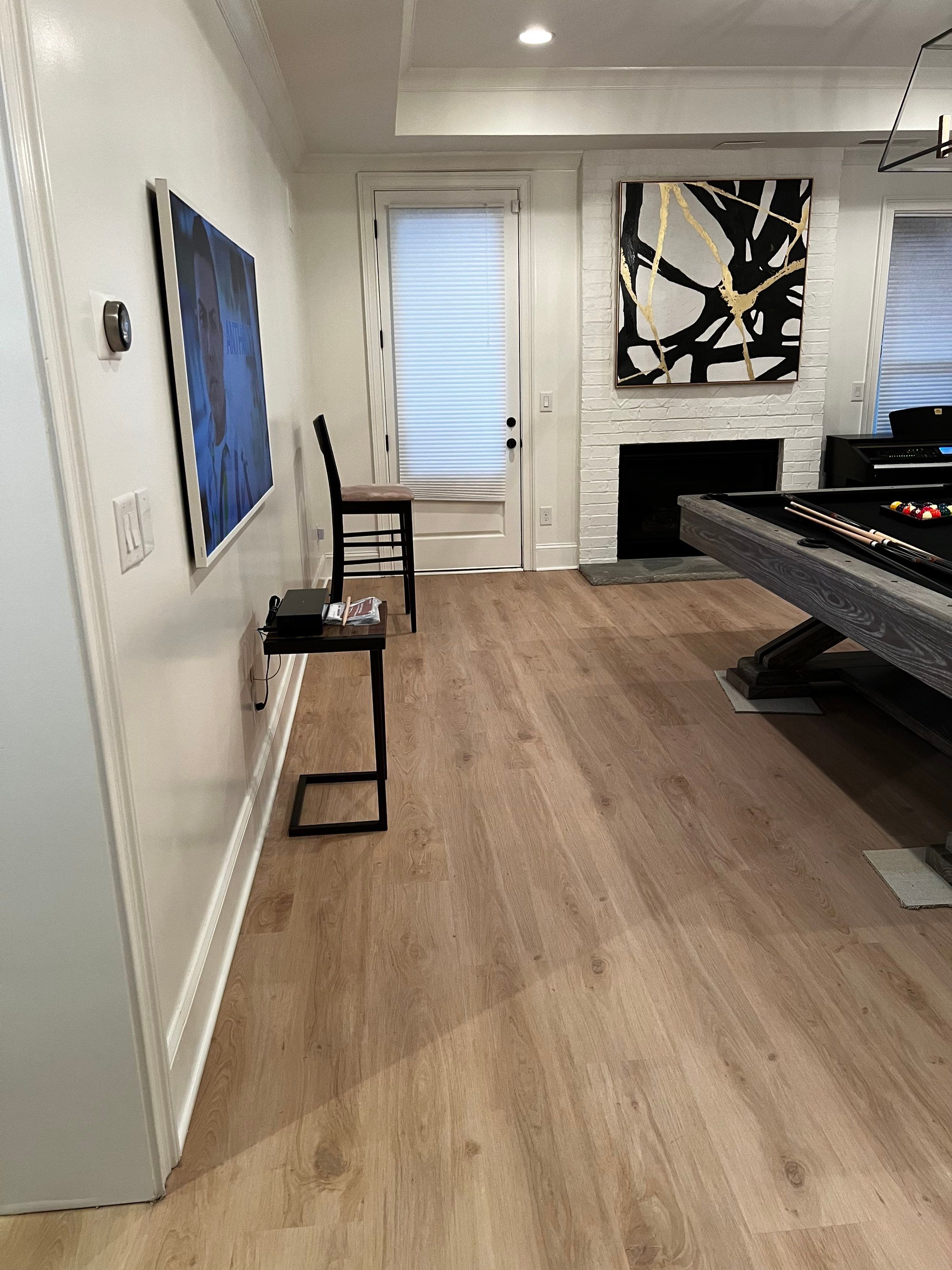 Atlanta Basement Refinishing with Wood Laminate Flooring and Interior Painting by Swift Home Renovations