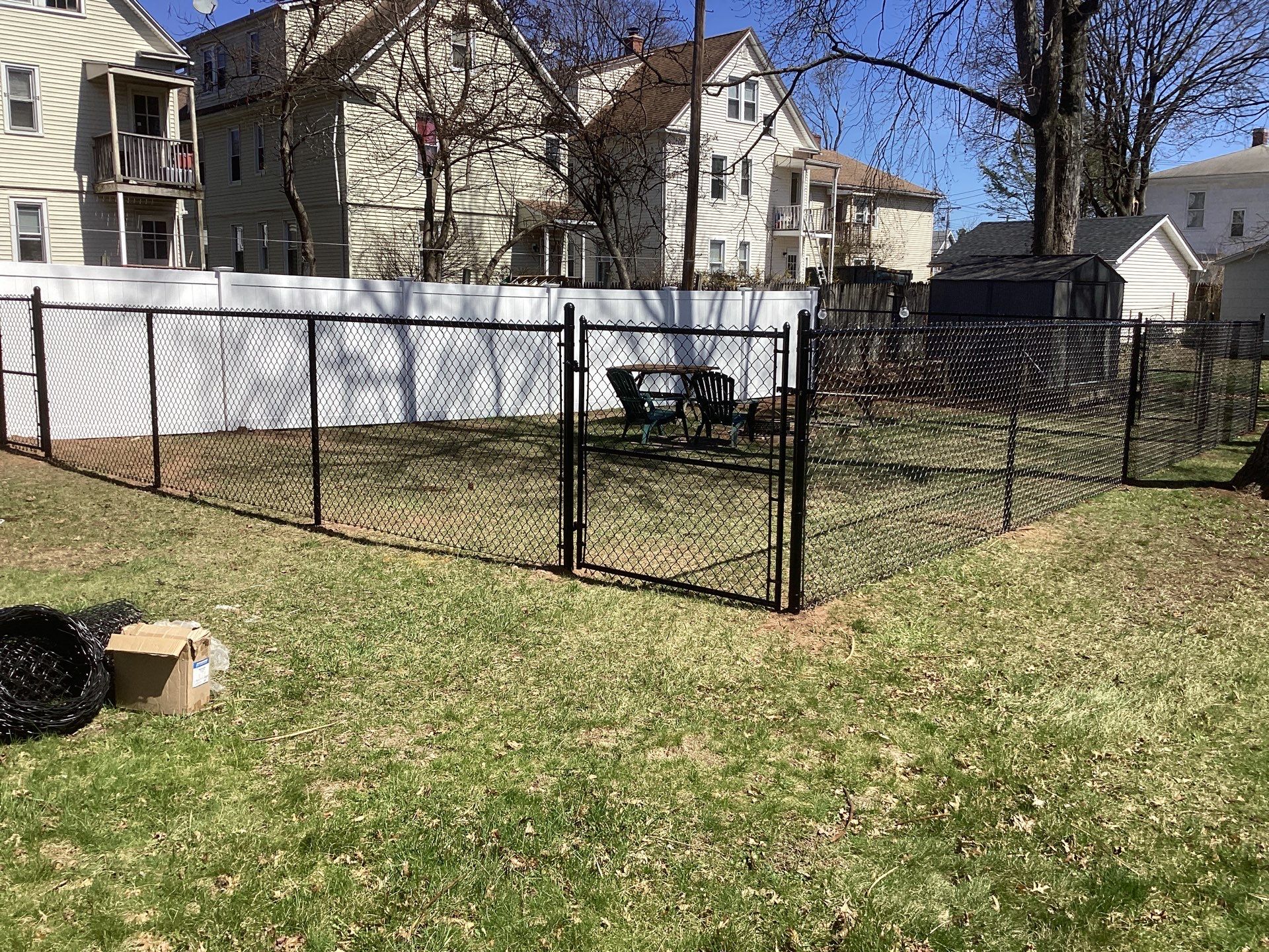 New Black Chain link and White Vinyl privacy fence with matching chain link gate. by DiGiorgi Roofing and Siding Inc