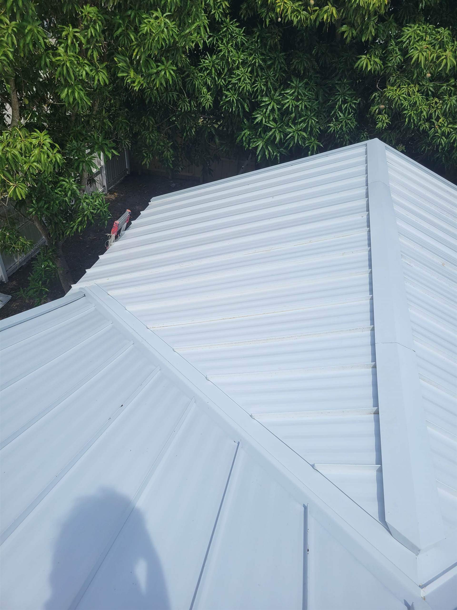 Standing Seam Metal & Flat Re-Roof using 1.5" Nail Strip 24ga Solar White Kynar Coated Standing Seam Metal Panels by Morton Roofing, Inc.