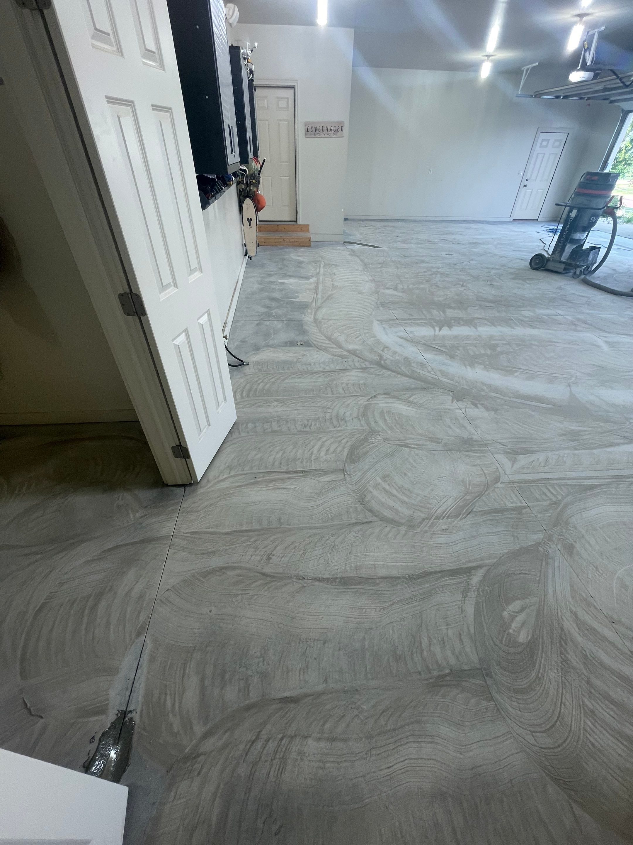 Coyote Flake Garage Floor Coating in Sioux Falls with Trench Drain by Select Painting, Coatings & Garage Cabinets