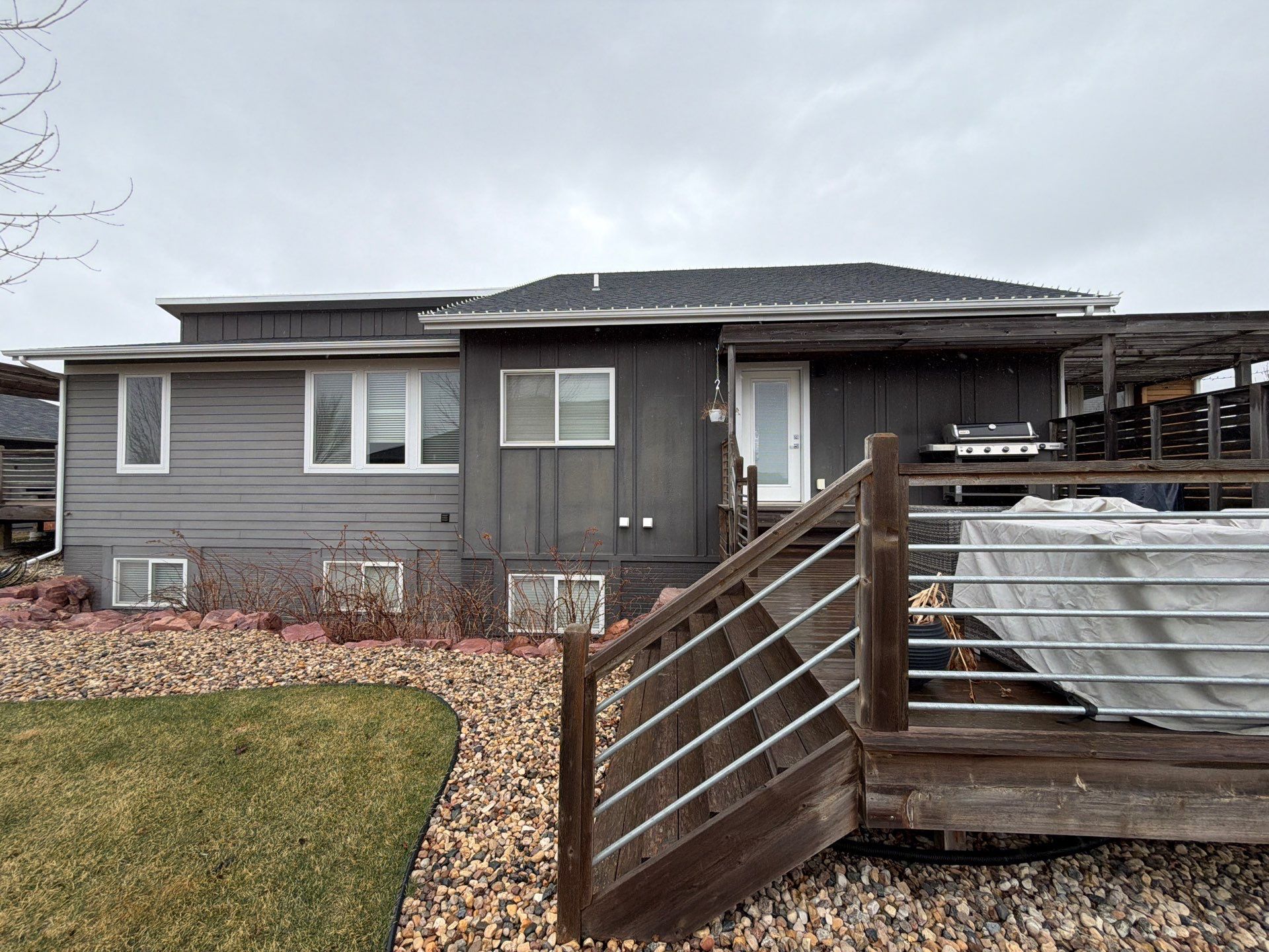 Modern Exterior Transformation Featuring Dark Board and Batten Siding in Sioux Falls by Select Painting, Coatings & Garage Cabinets
