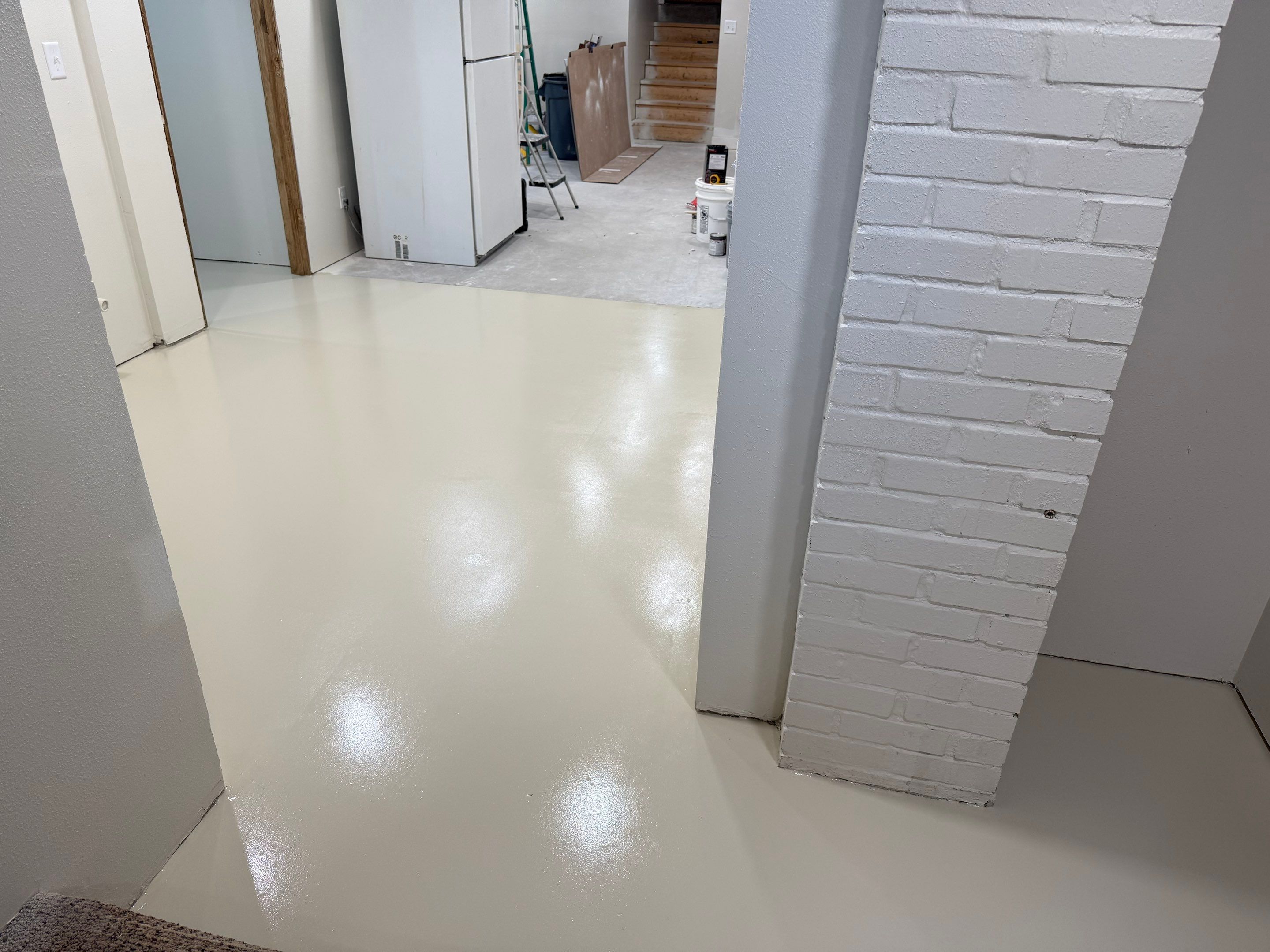 High-Gloss Epoxy Floor Coating and Basement Renovation in Rock Rapids by Select Painting, Coatings & Garage Cabinets