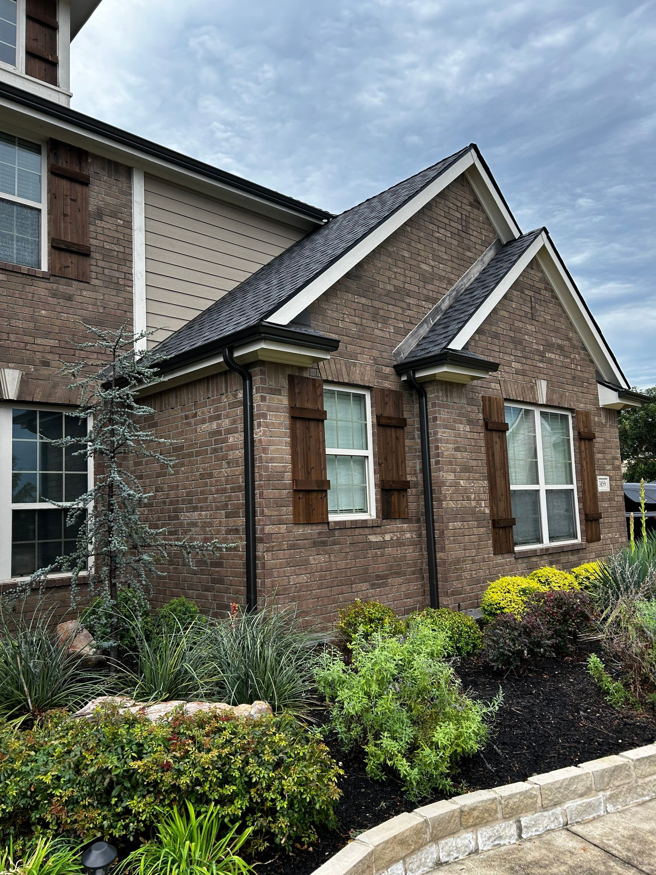 Medium brown brick with GAF Pewter Gray  by Tejas Roofworks + Restoration