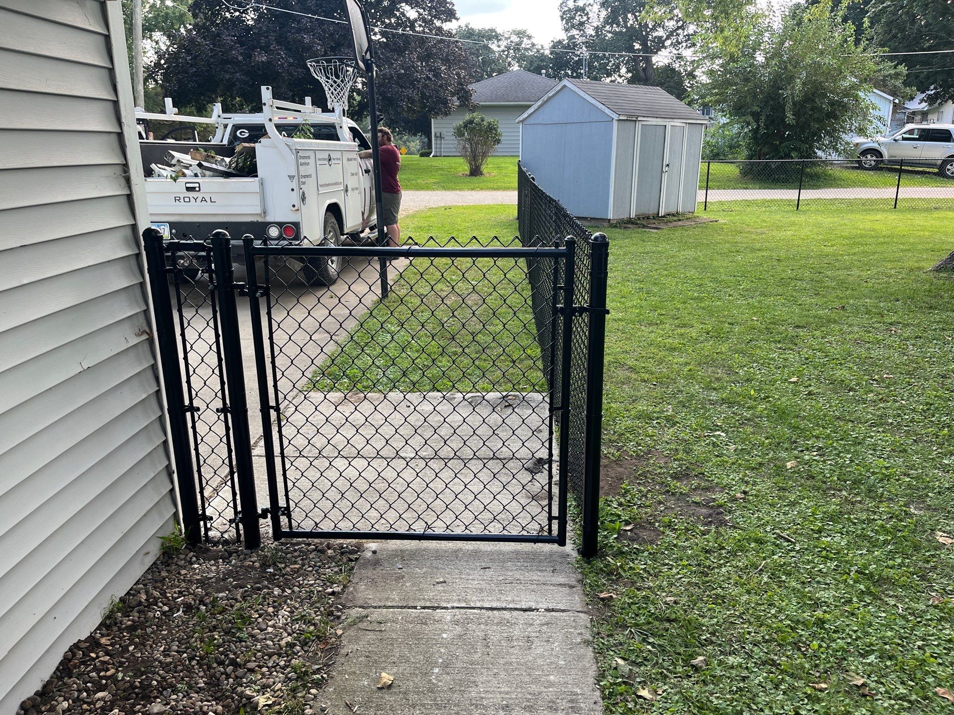 Black Chain Link Perimeter Fence and Gate Installation in Shell Rock by Perfect Picket Fence and Stain