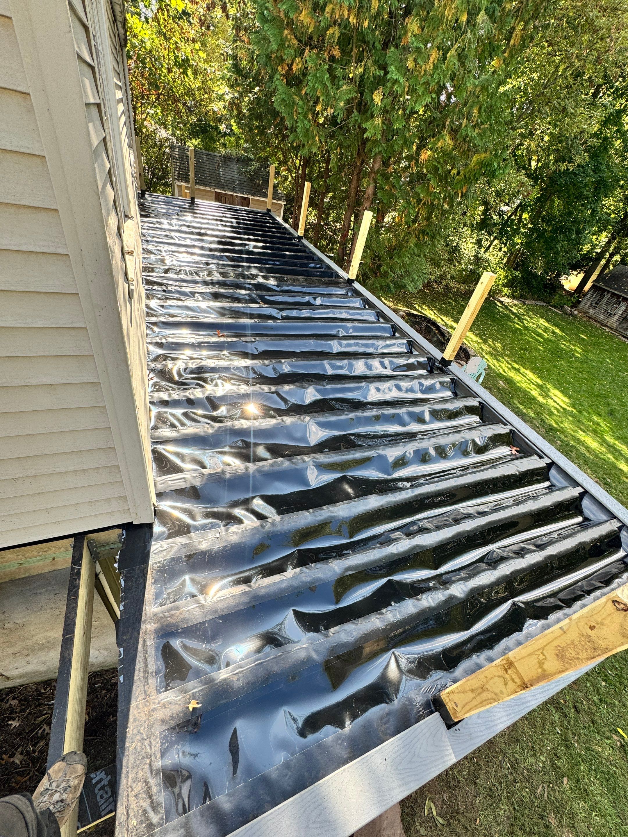 New Deck, Trex Select Pebble Gray boards, Composite railings in white, Trex Rainescape system, and gate. by DiGiorgi Roofing and Siding Inc