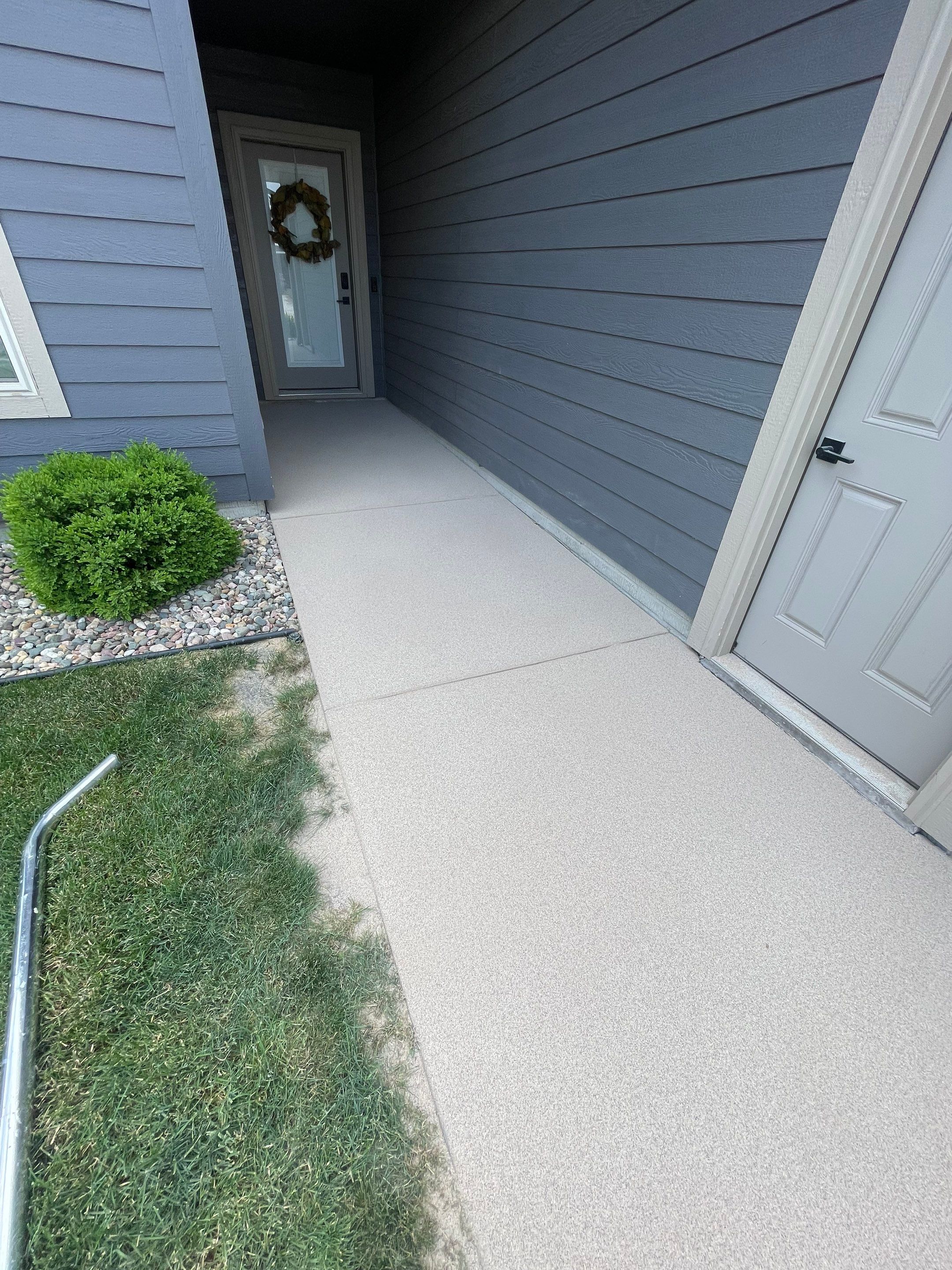 Textured Concrete Patio Coating and Custom Privacy Pergola in Sioux Falls by Select Painting, Coatings & Garage Cabinets