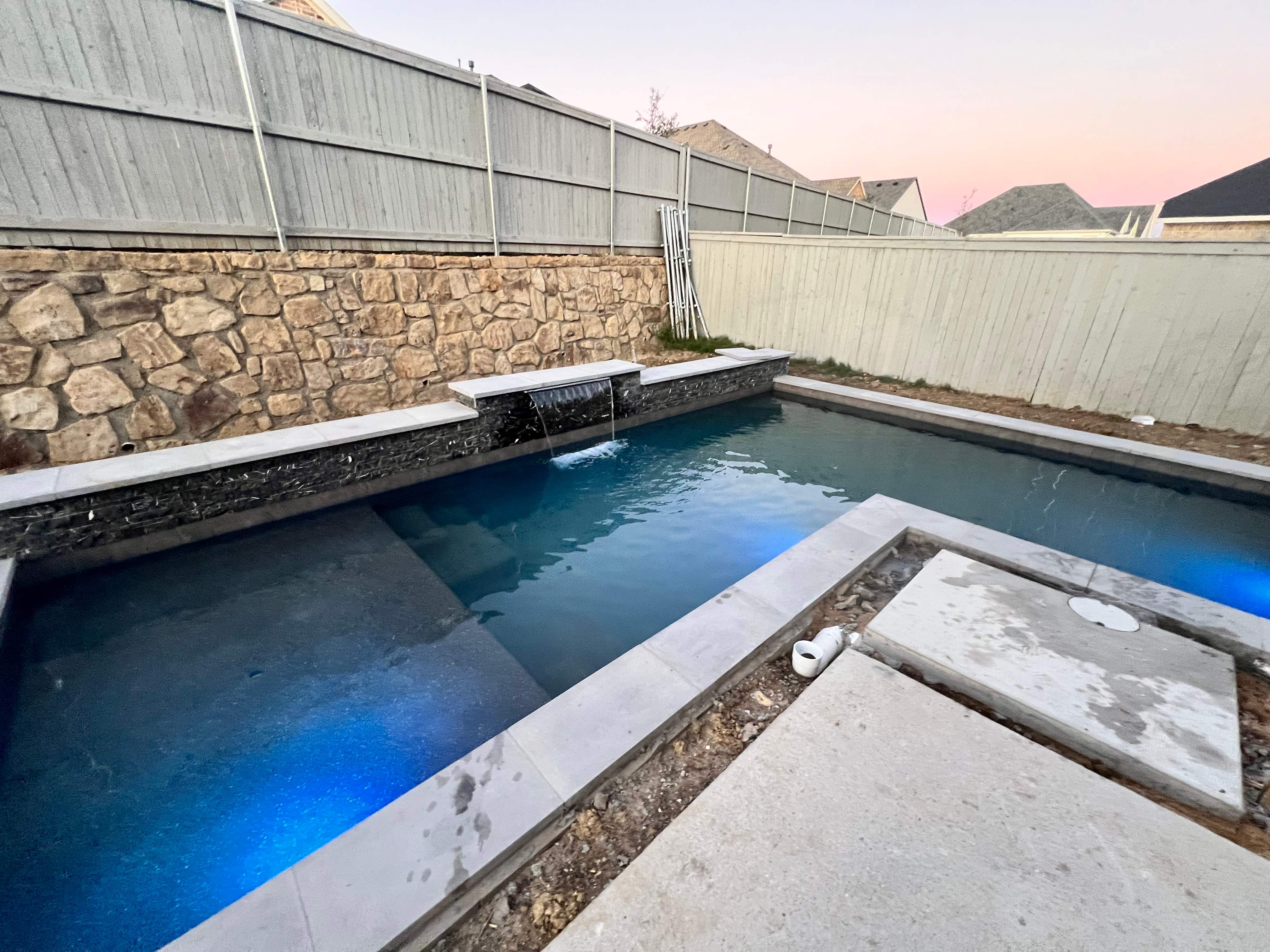 Geometric Pool with Raised Spa and Dusk Lighting by Pinnacle Pools and Spas - DFW
