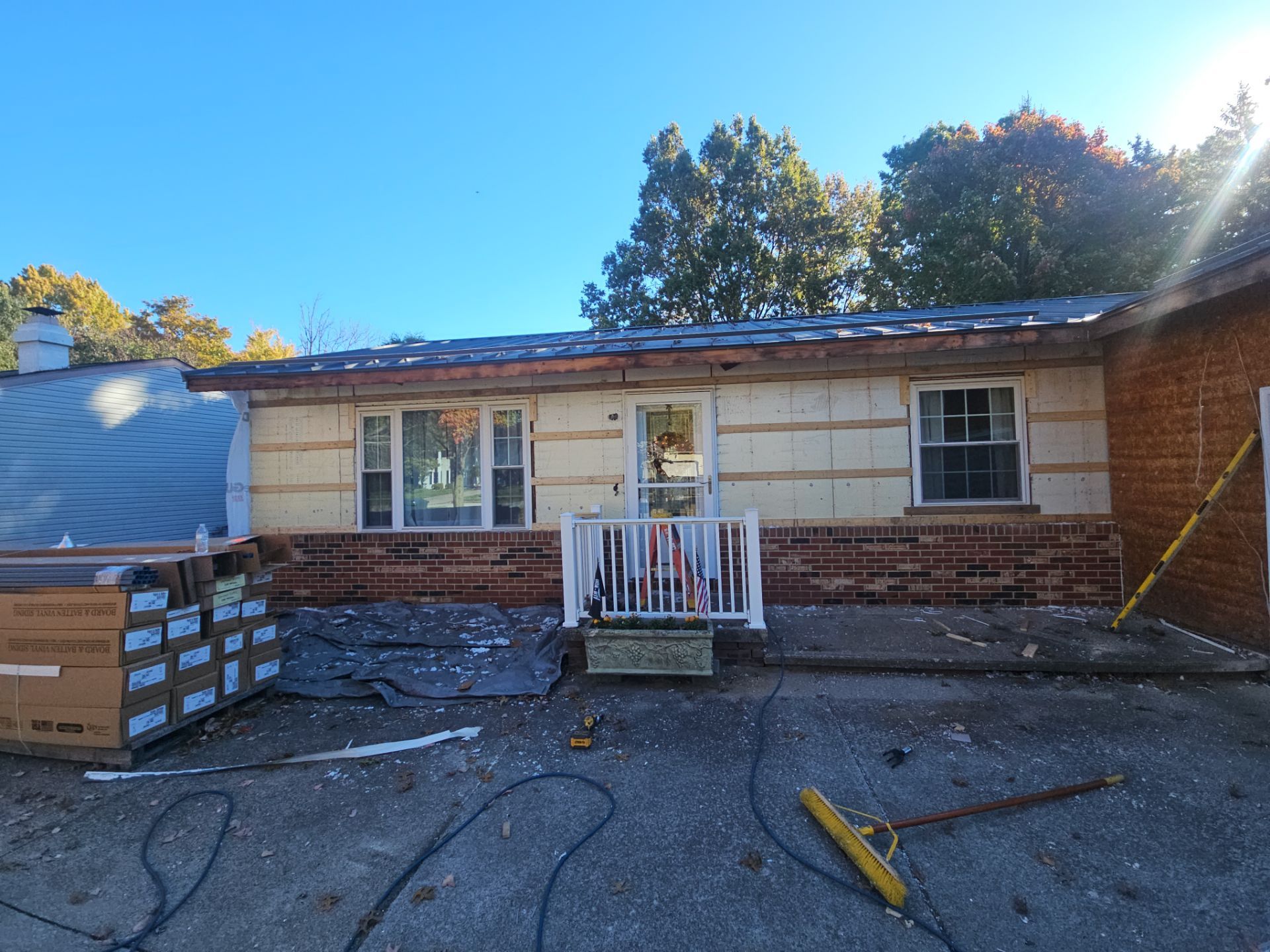 Wadsworth Exterior Transformation Featuring Blue Vertical Siding and Metal Roofing by Cornerstone Roofing And Siding