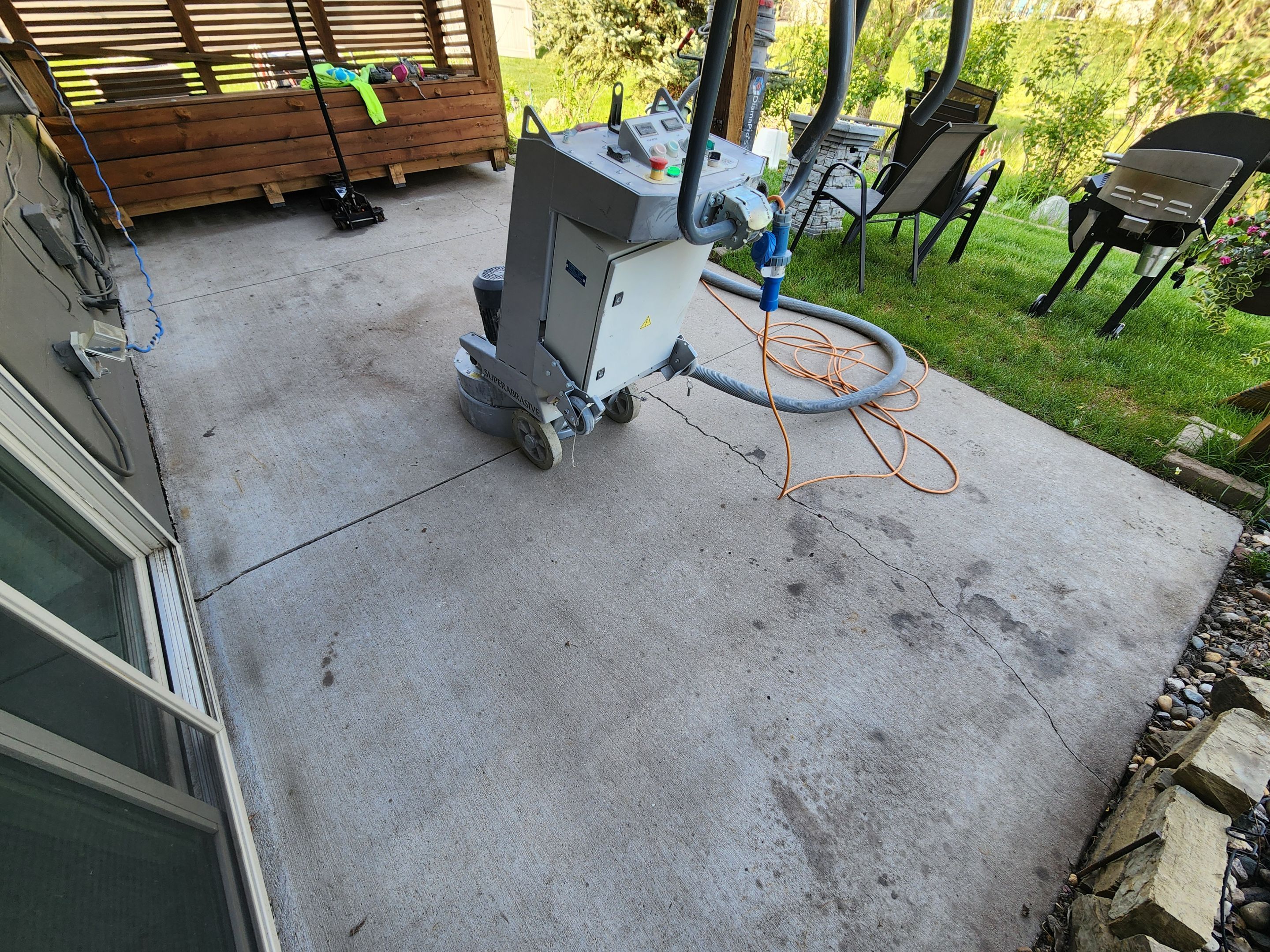 Coyote Flake Concrete Coating for Sioux Falls Patio by Select Painting, Coatings & Garage Cabinets