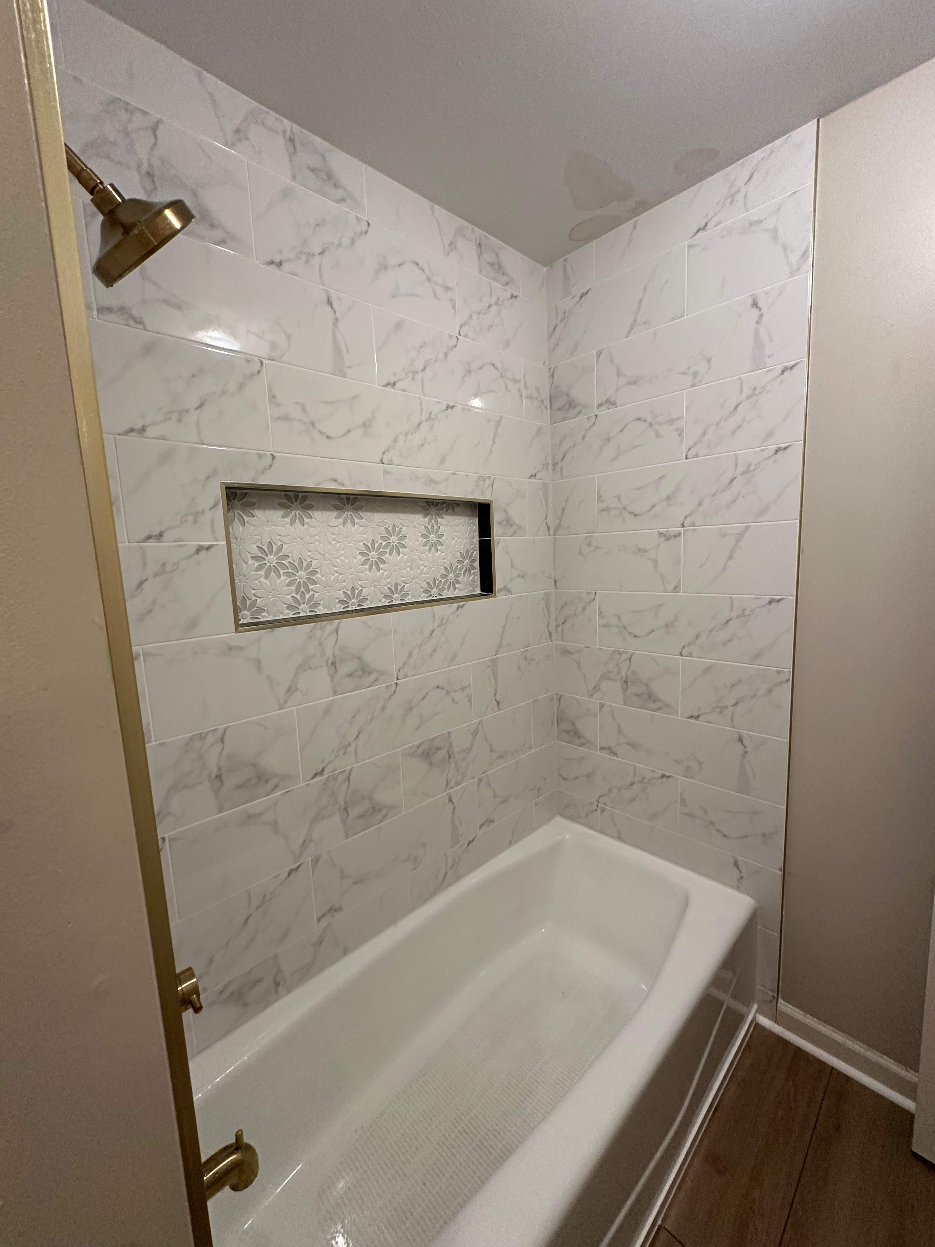 Tub retile, floor, vanities, mirror, and lights by Prudencio
