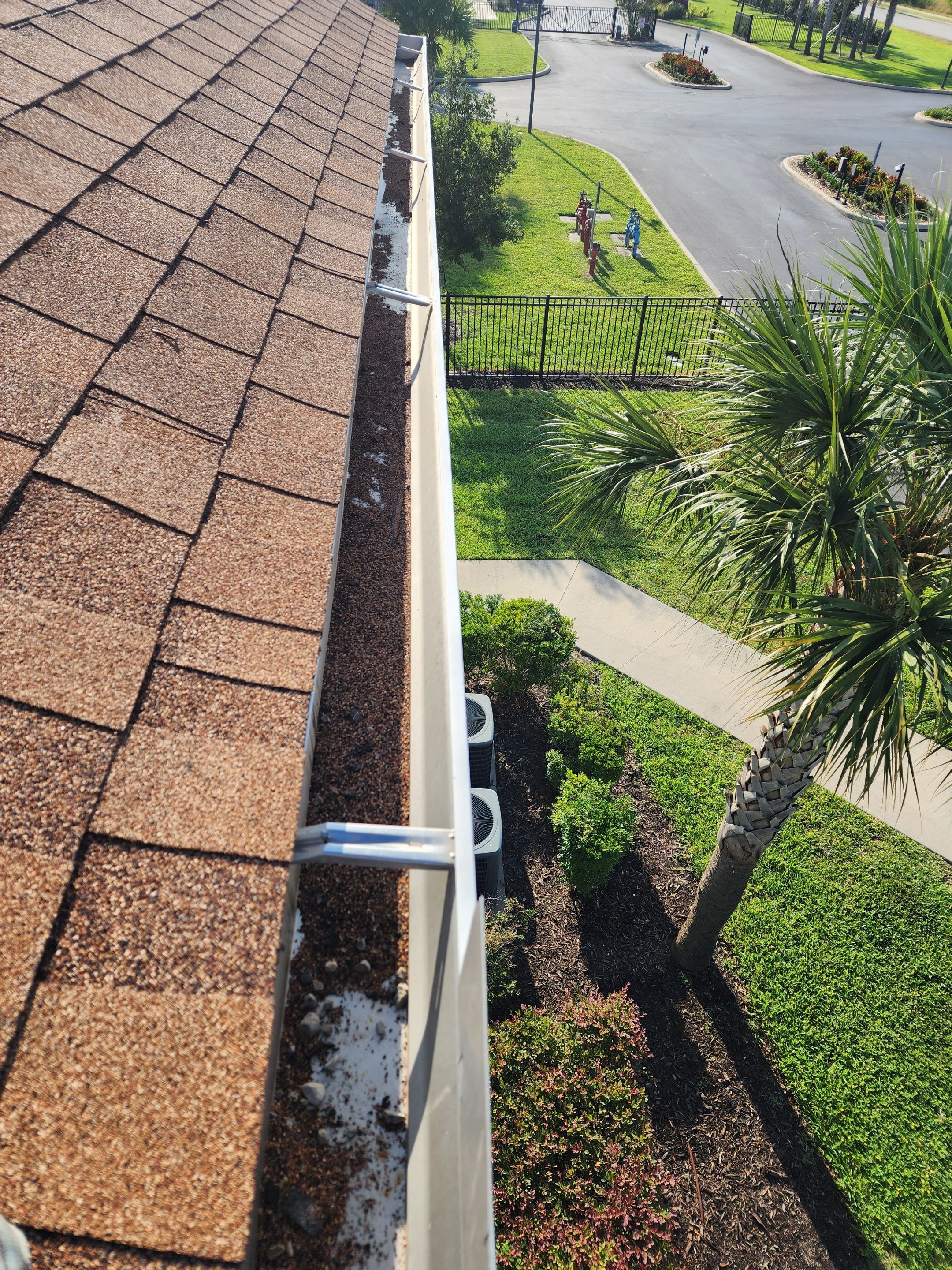 HOA gutter cleaning in Port Charlotte, FL,before photo showing full gutters.