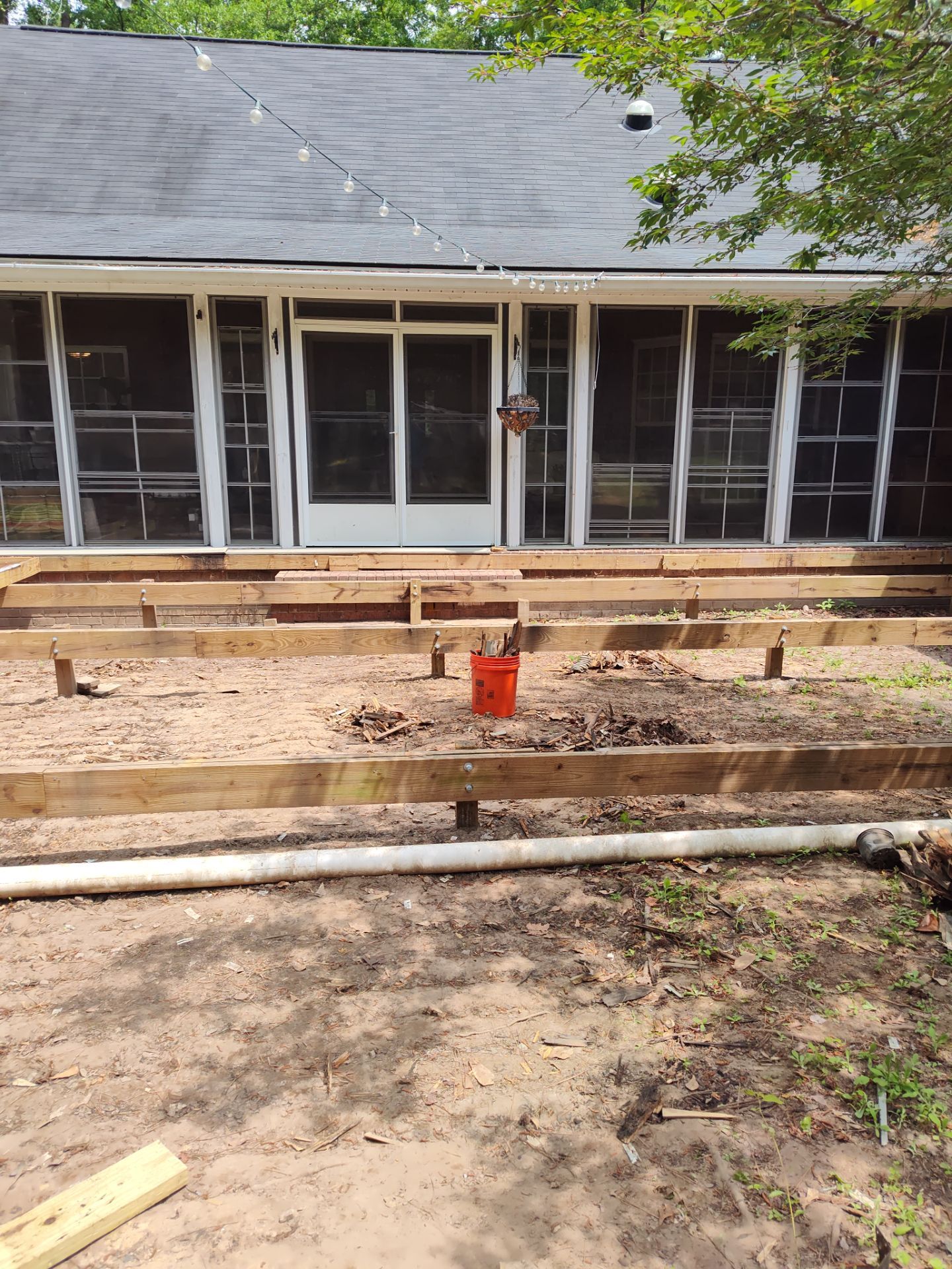 Patio in concrete with drainage improvements by Cornerstone Home Builders, LLC