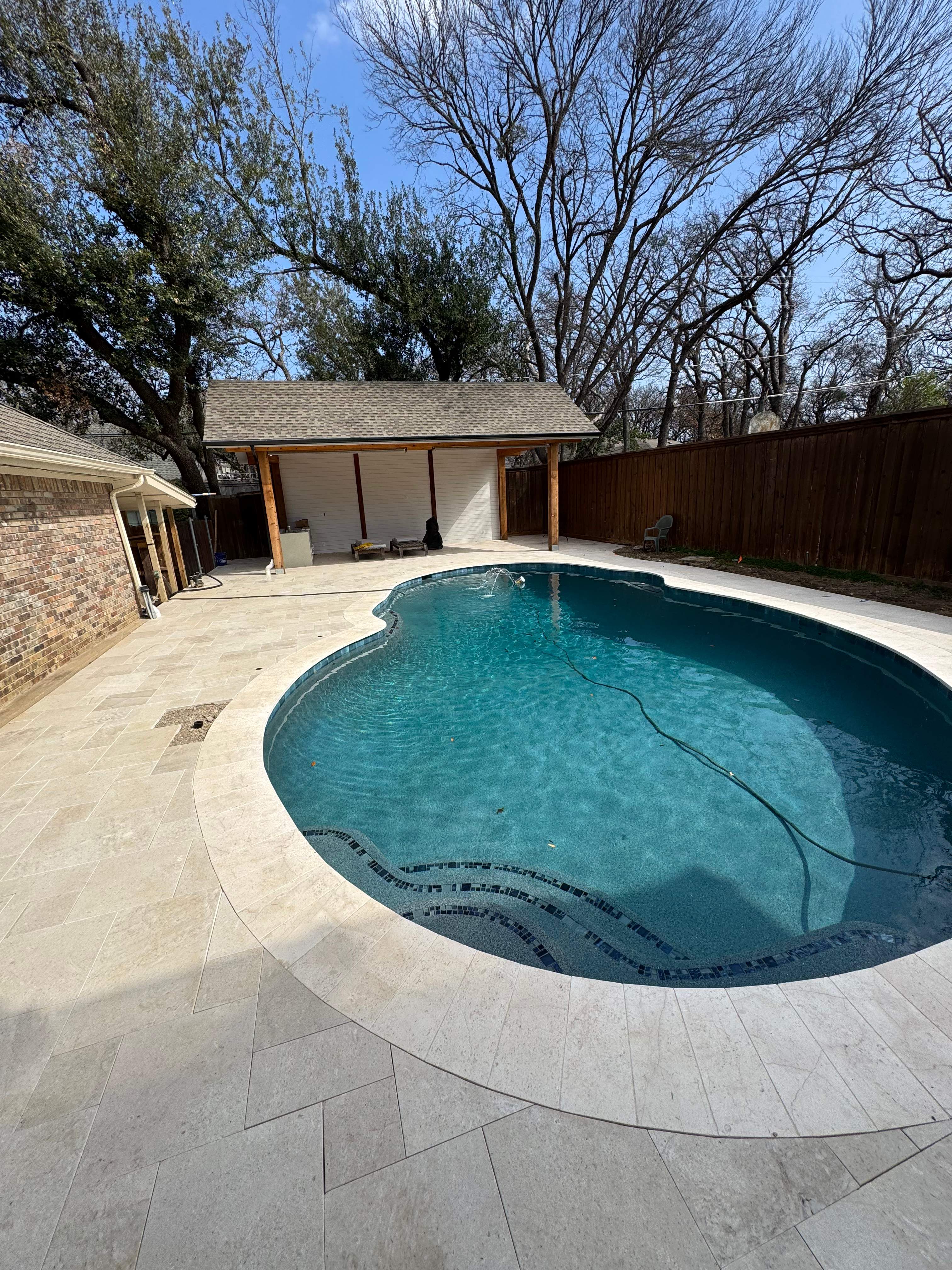 Freeform Pool Remodel with Travertine Deck and Deck Jets by Pinnacle Pools and Spas - DFW