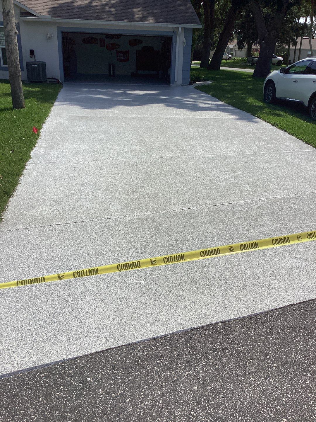 Driveway and Garage using Tidal Wave by Amvet concrete coatings llc