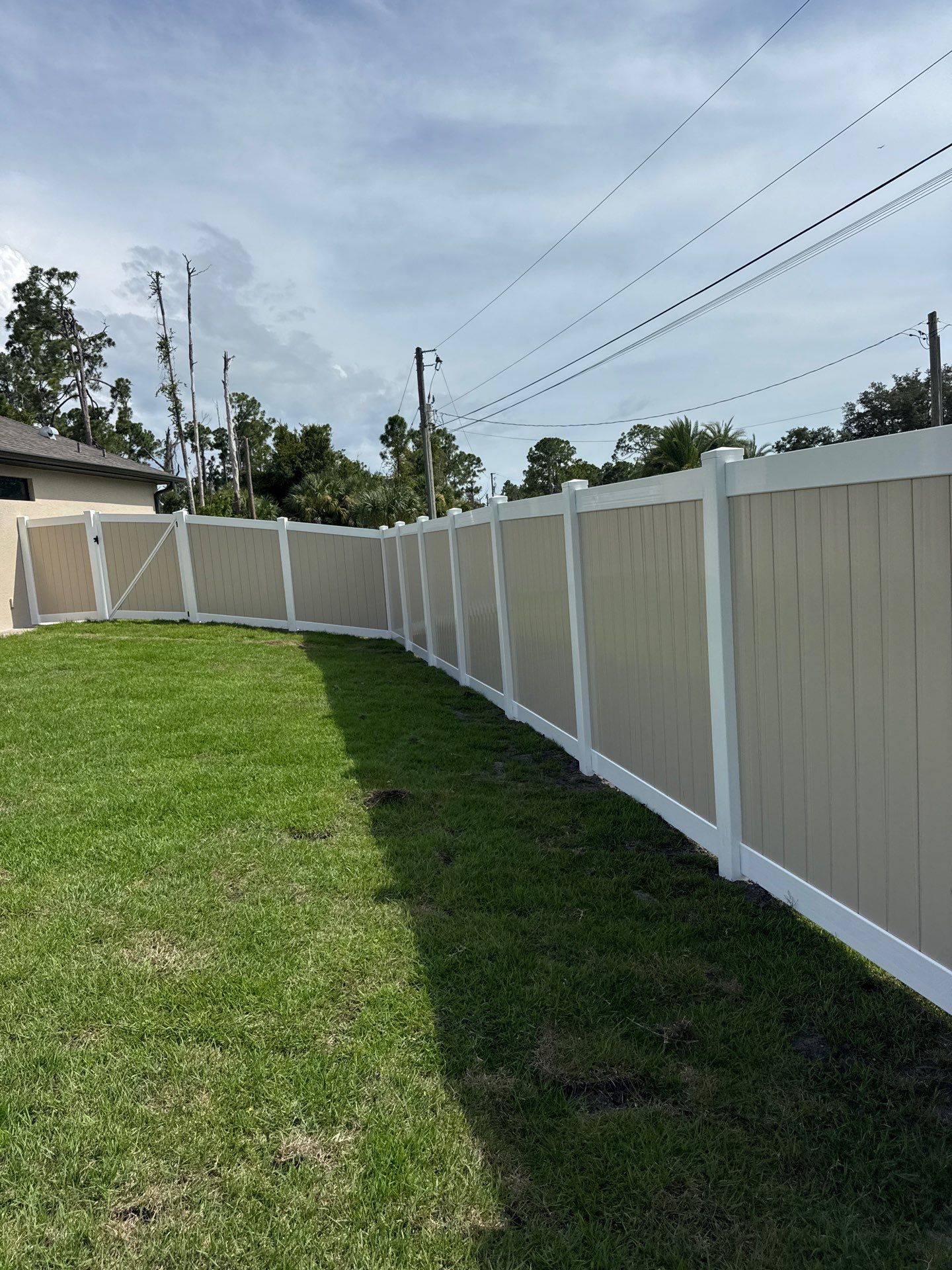 Custom Two-Tone Vinyl Privacy Fence Installation in North Port by True Fence LLC
