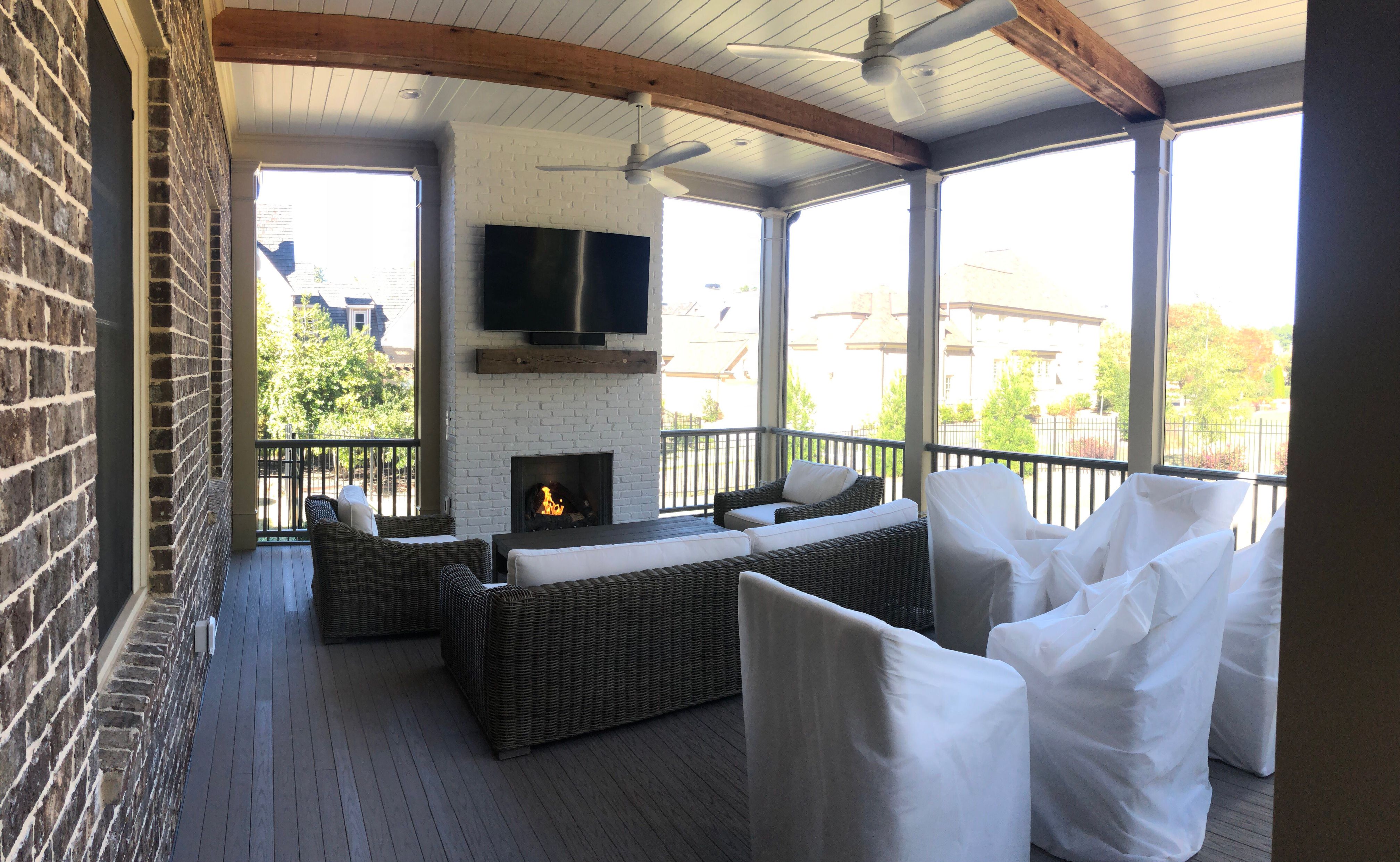 Custom Screened Porch Addition with White Brick Fireplace in Duluth by Swift Home Renovations
