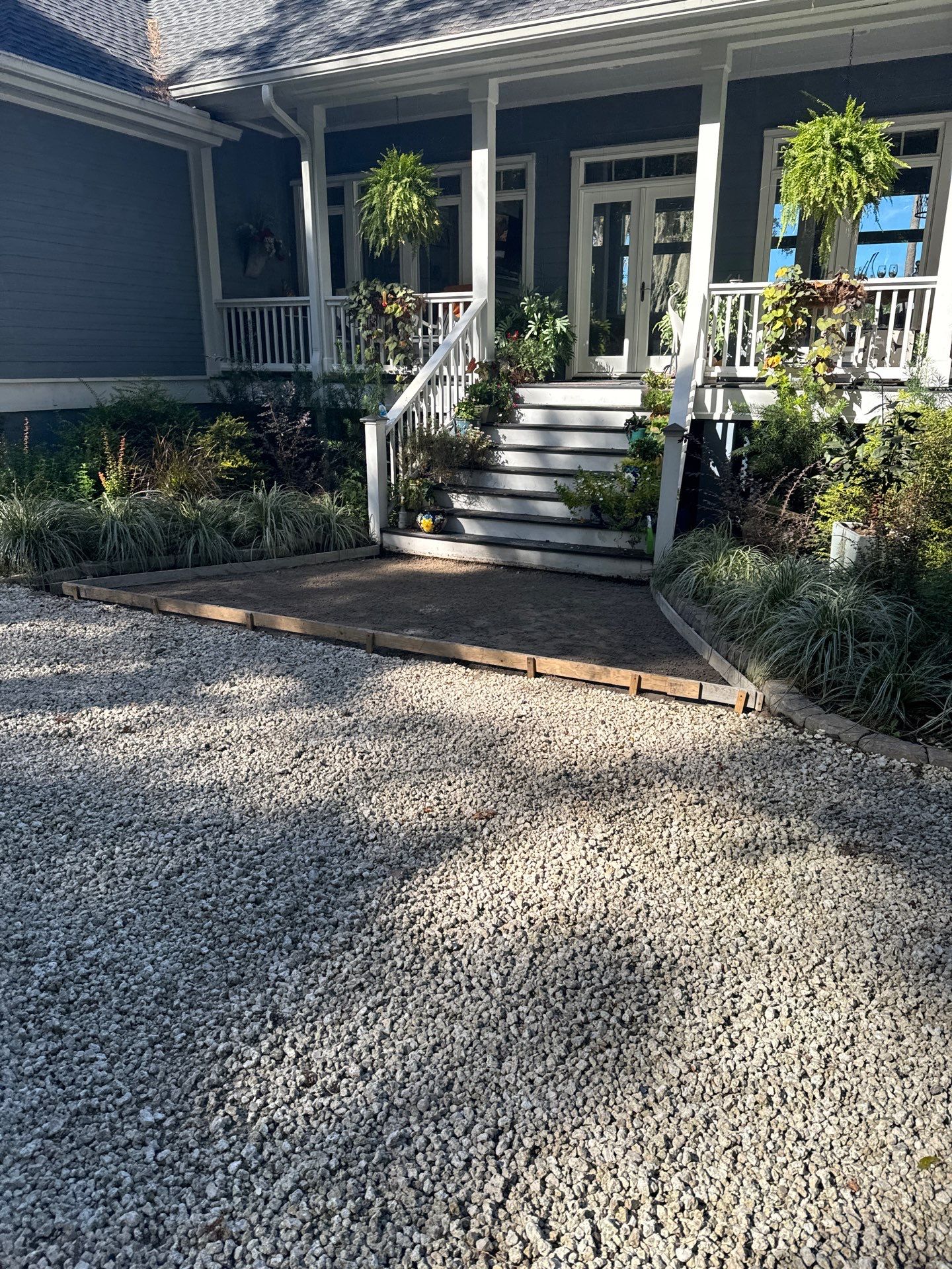 Concrete Driveway and Patio Installation With Decorative Brick Borders by Lowcountry Scapes, LLC