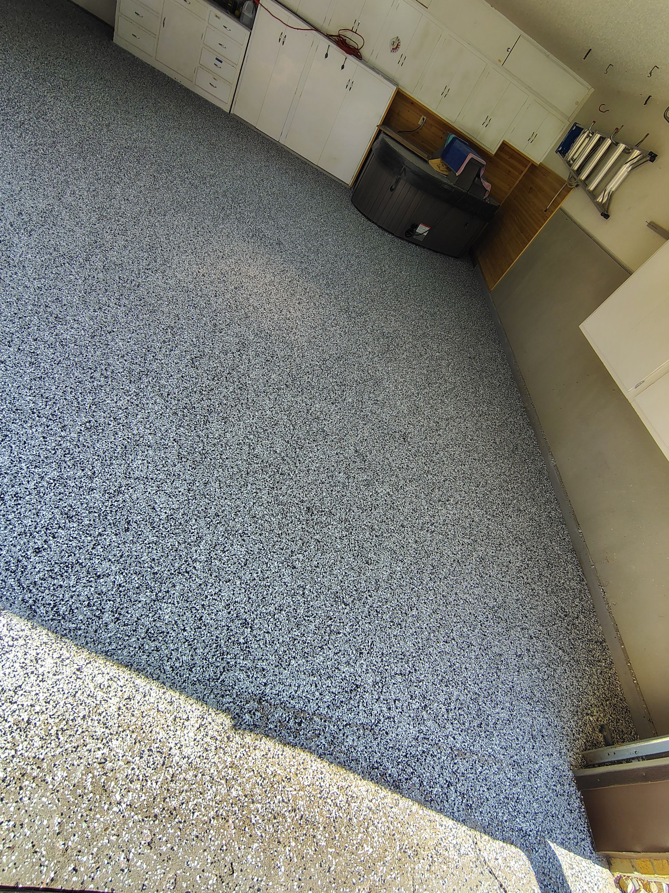 Domino Flake Garage Floor Coating Installation in Sioux Falls by Select Painting, Coatings & Garage Cabinets