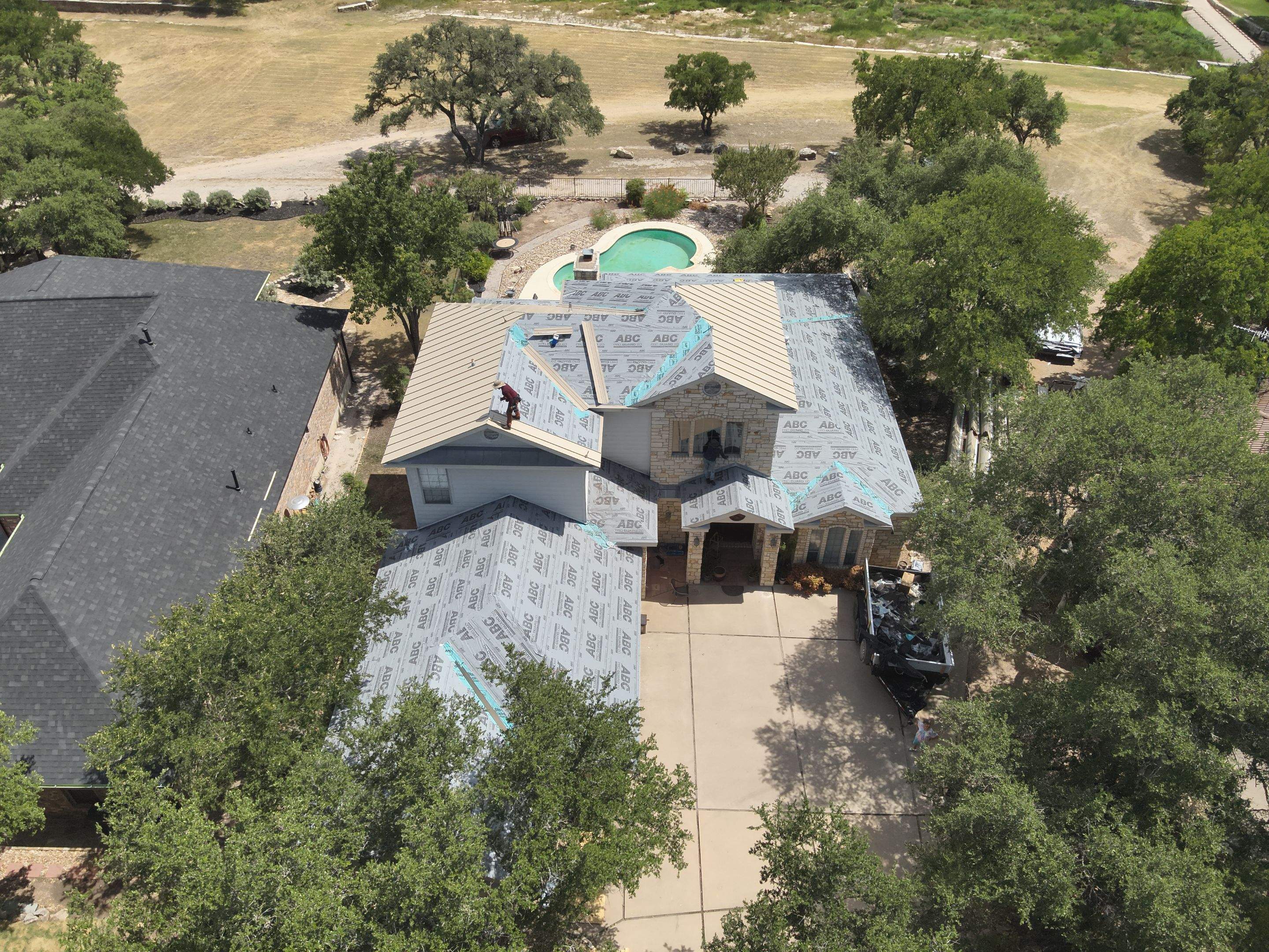 Residential Roof Replacement using 24 GA Double-Lock - Surrey Beige by Action Exteriors Austin