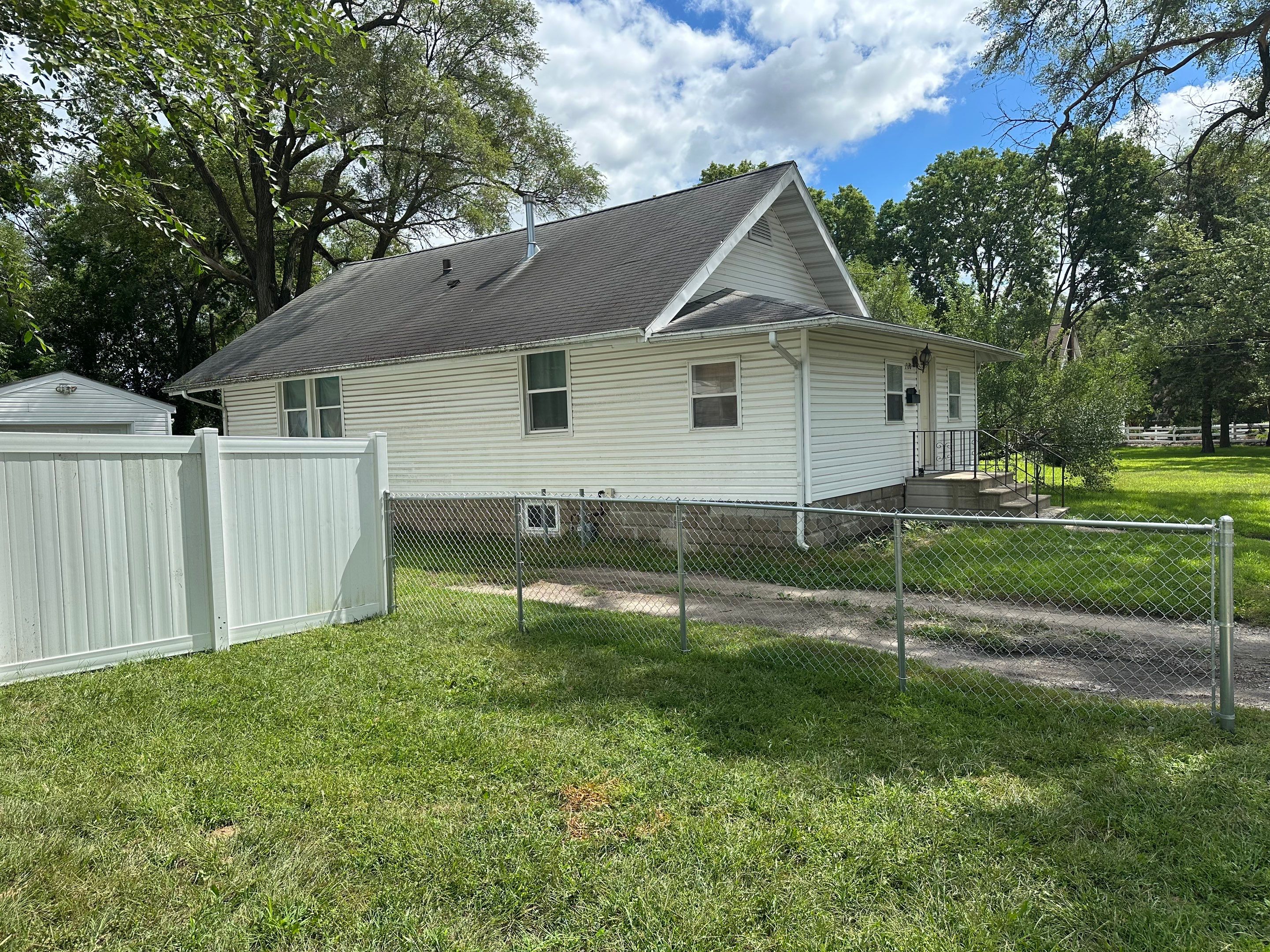 Residential White Vinyl Privacy Fence Installation in Waterloo, Iowa by Perfect Picket Fence and Stain