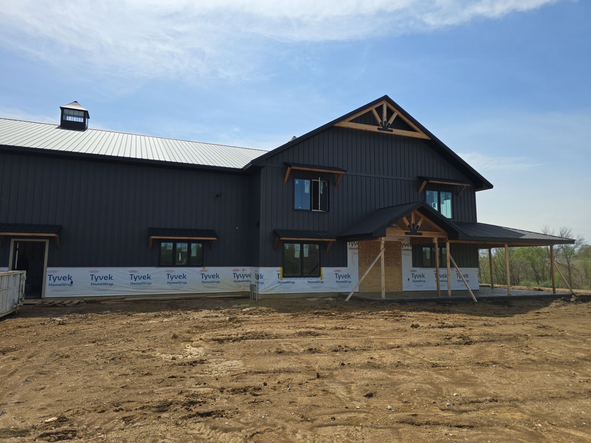 New Home construction w/ board and batten sides and metal roof  by Miles Construction 