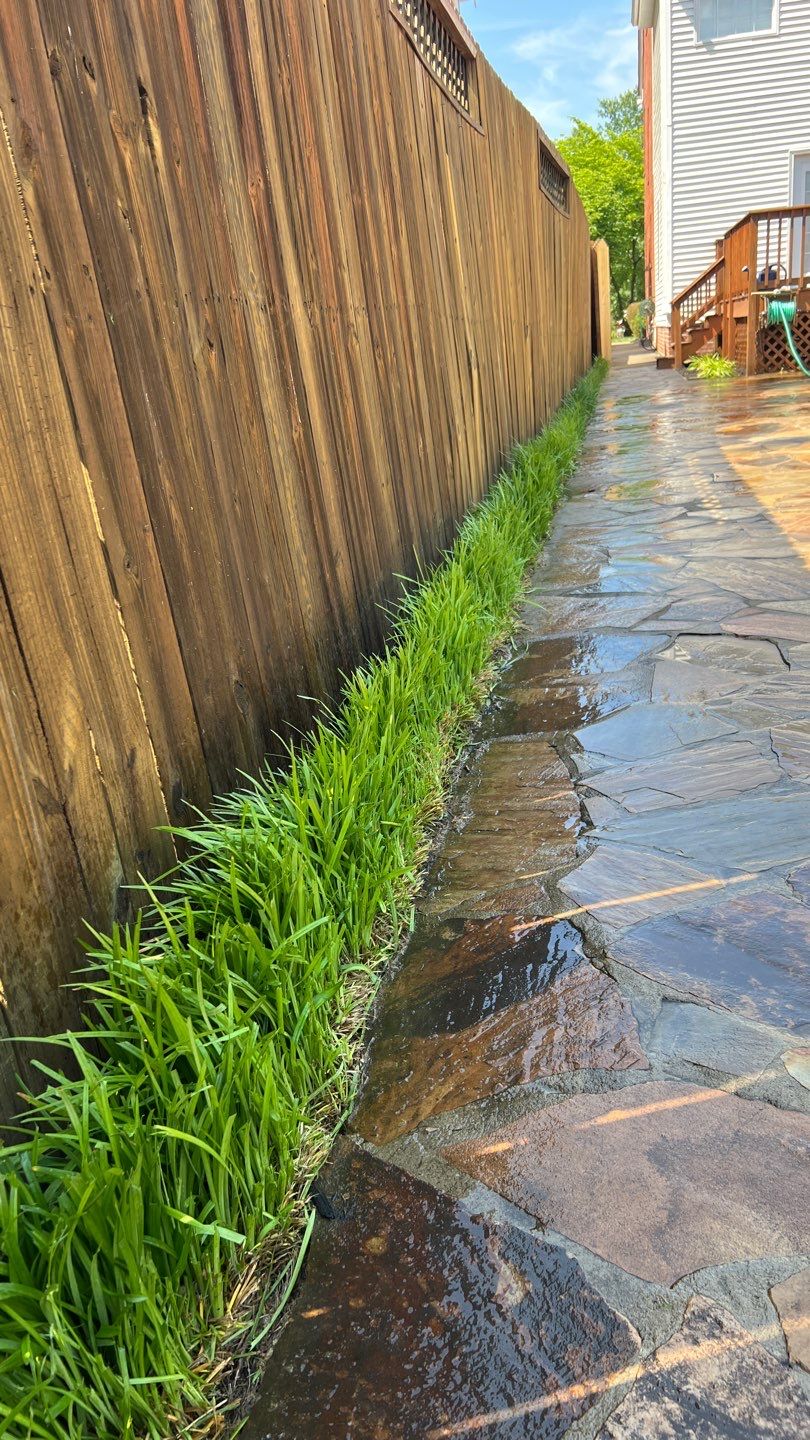 Liriope grasses, mulch and stone pavers by GrassBusters, Inc.